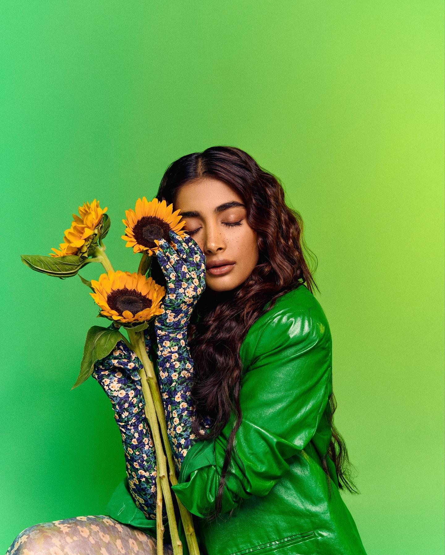 Pooja Hegde Holding Sunflowers in a Shiny Green Outfit