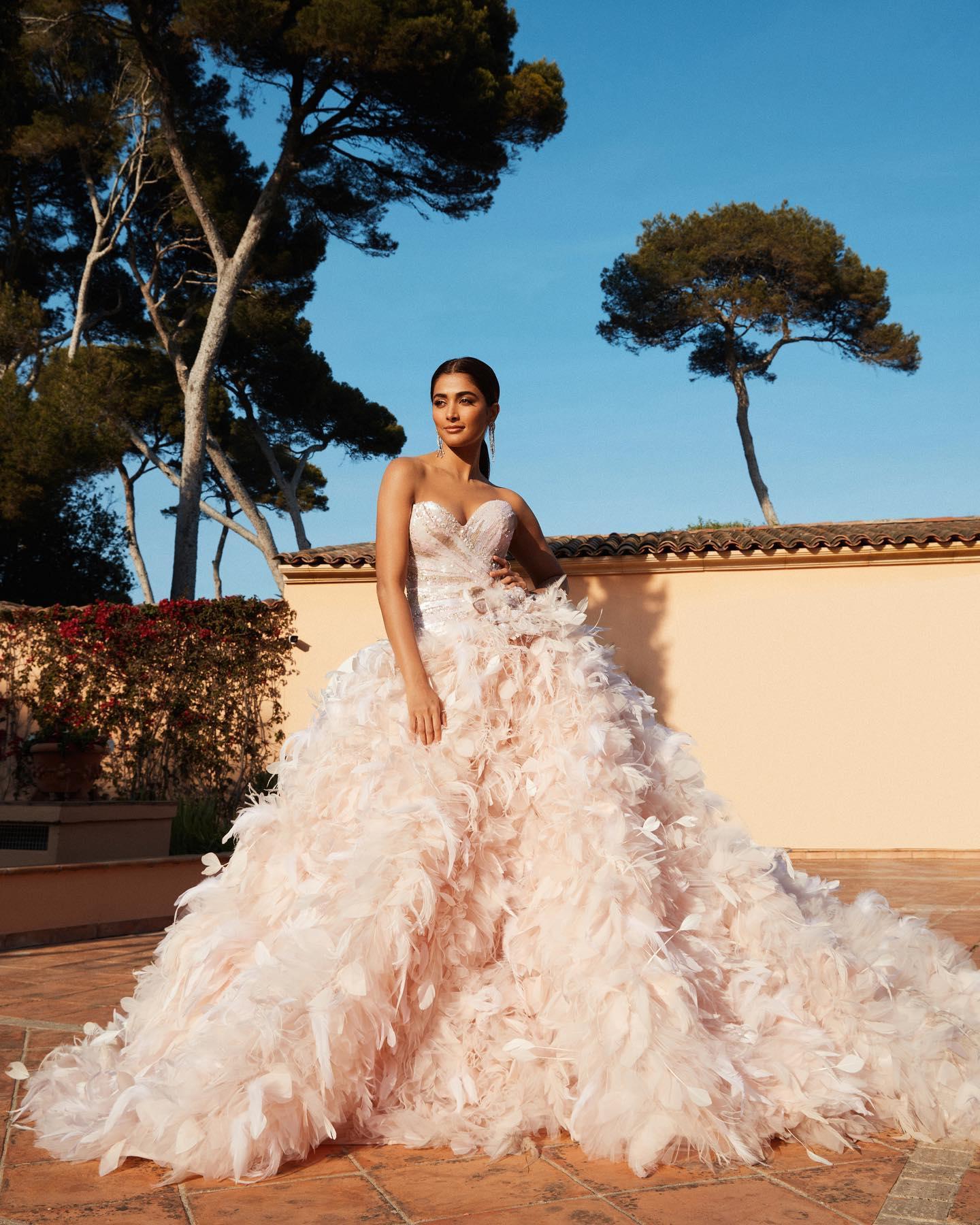 Pooja Hegde in a Peach Gown Outside a Scenic Villa Image