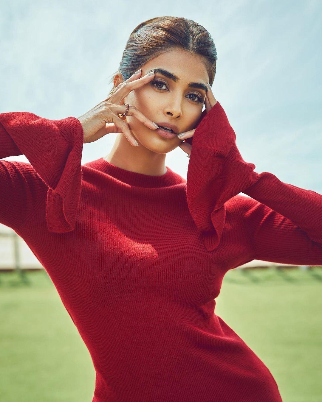 Pooja Hegde in a Stylish Red Top Posing with Hand Near Face