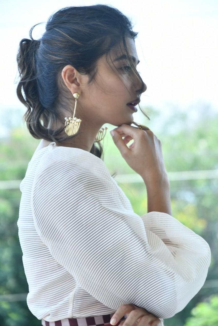 Pooja Hegde in a White Outfit with Elegant Earrings Image
