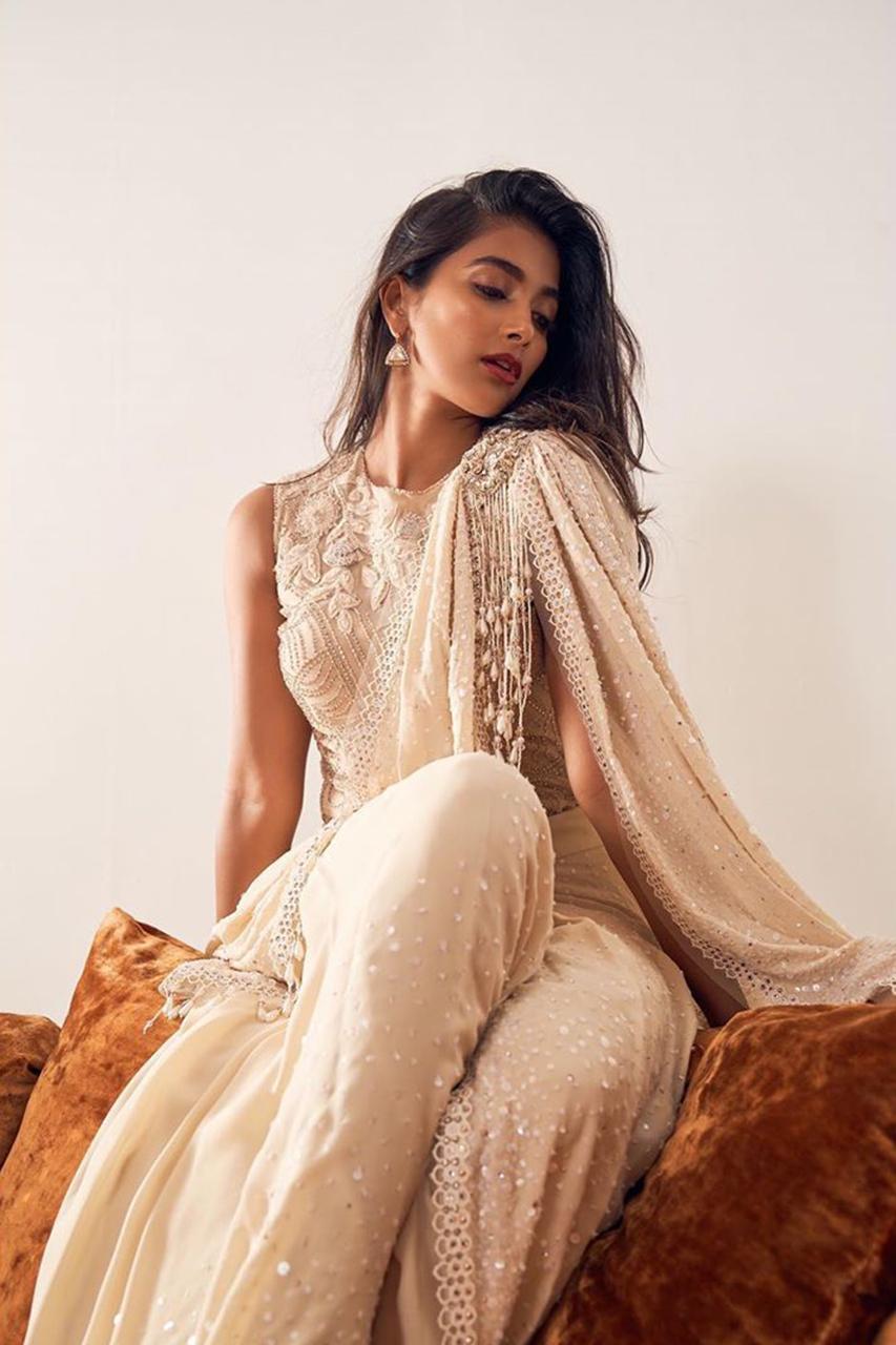 Pooja Hegde in Beige Designer Gown Sitting Gracefully