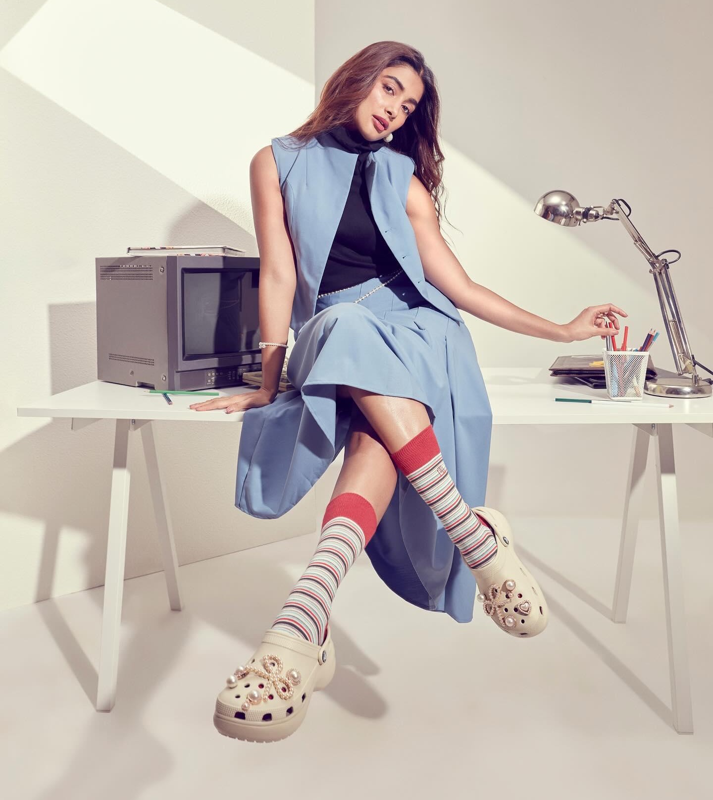 Pooja Hegde in Blue Dress Sitting on a White Desk Wallpaper