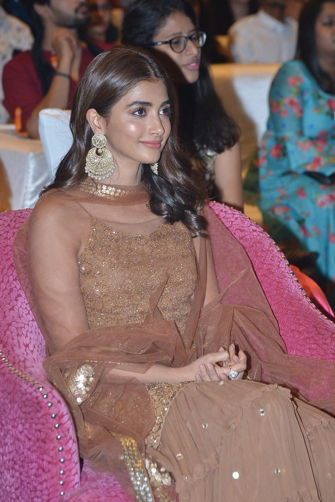 Pooja Hegde in Brown Gown Sitting At Formal Event Wallpaper