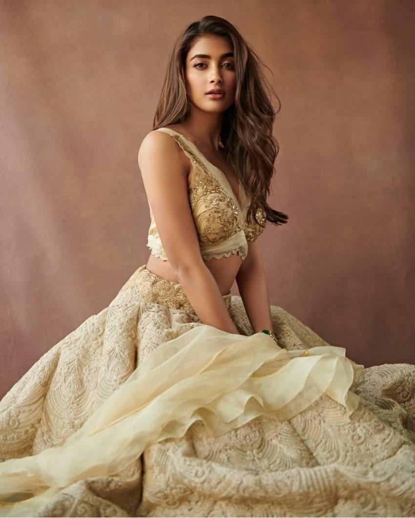 Pooja Hegde in Designer Beige Gown Sitting Gracefully Indoors
