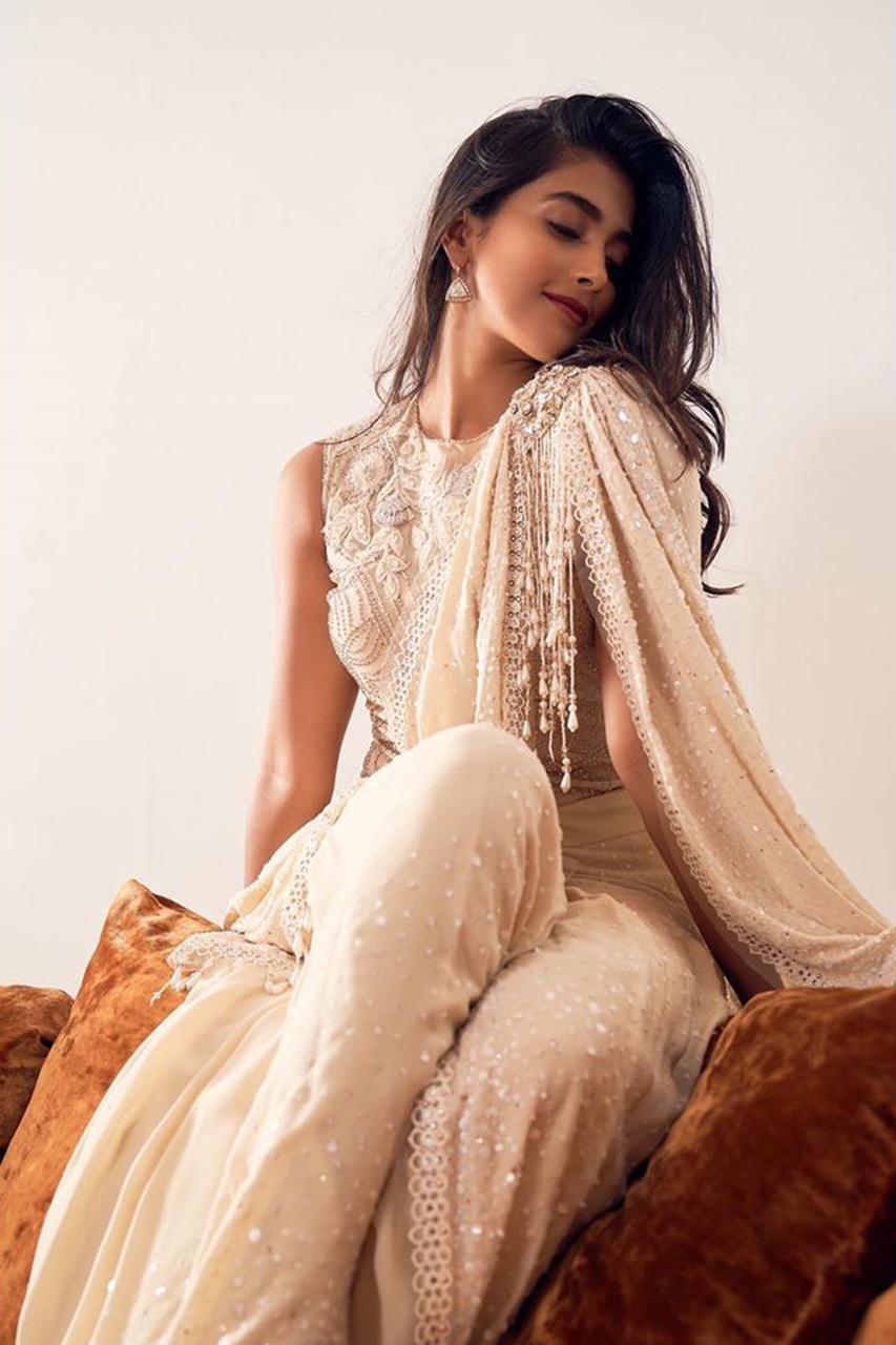 Pooja Hegde in Designer Outfit Sitting on Sofa Elegantly