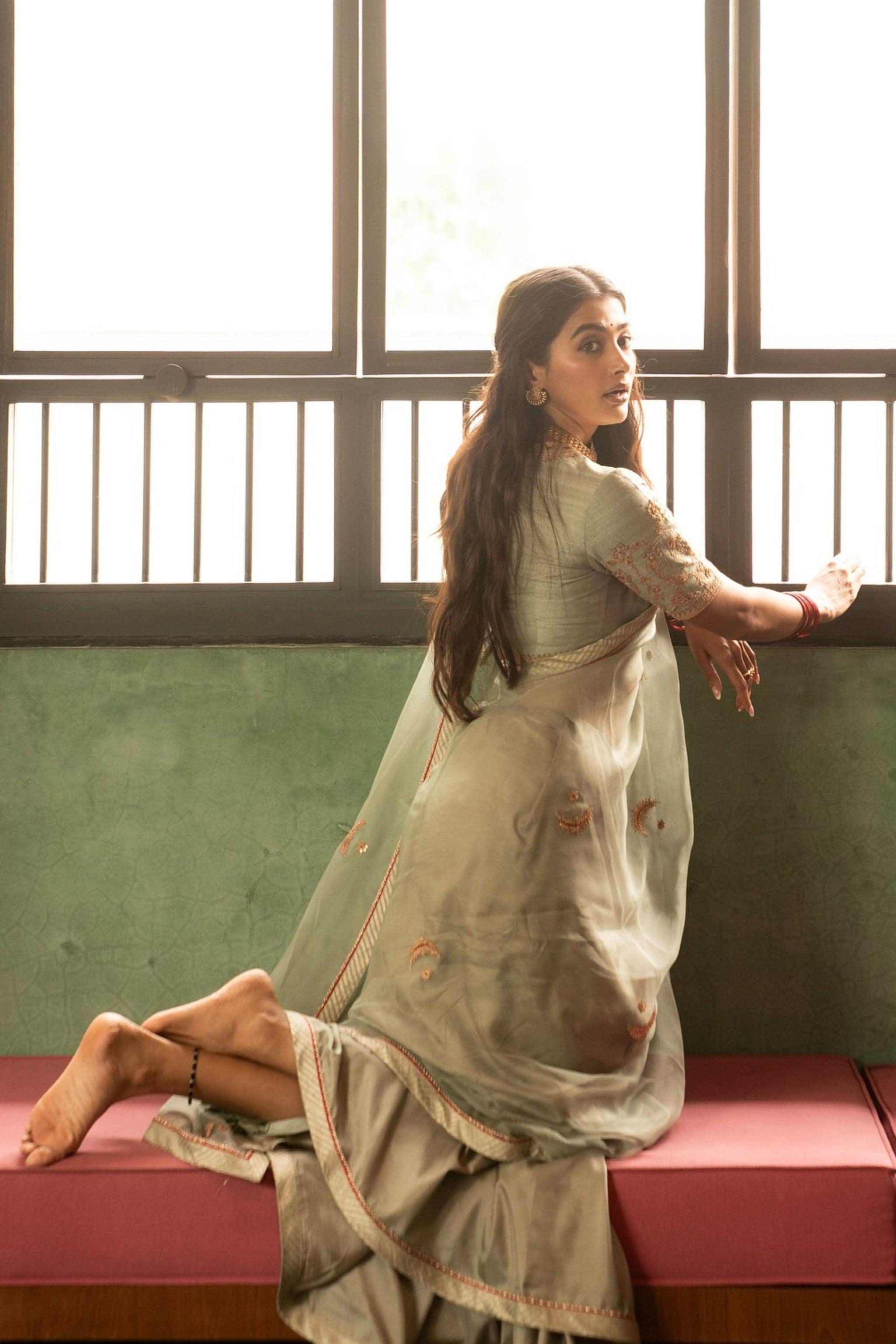 Pooja Hegde in Green Ethnic Attire Near Wooden Window
