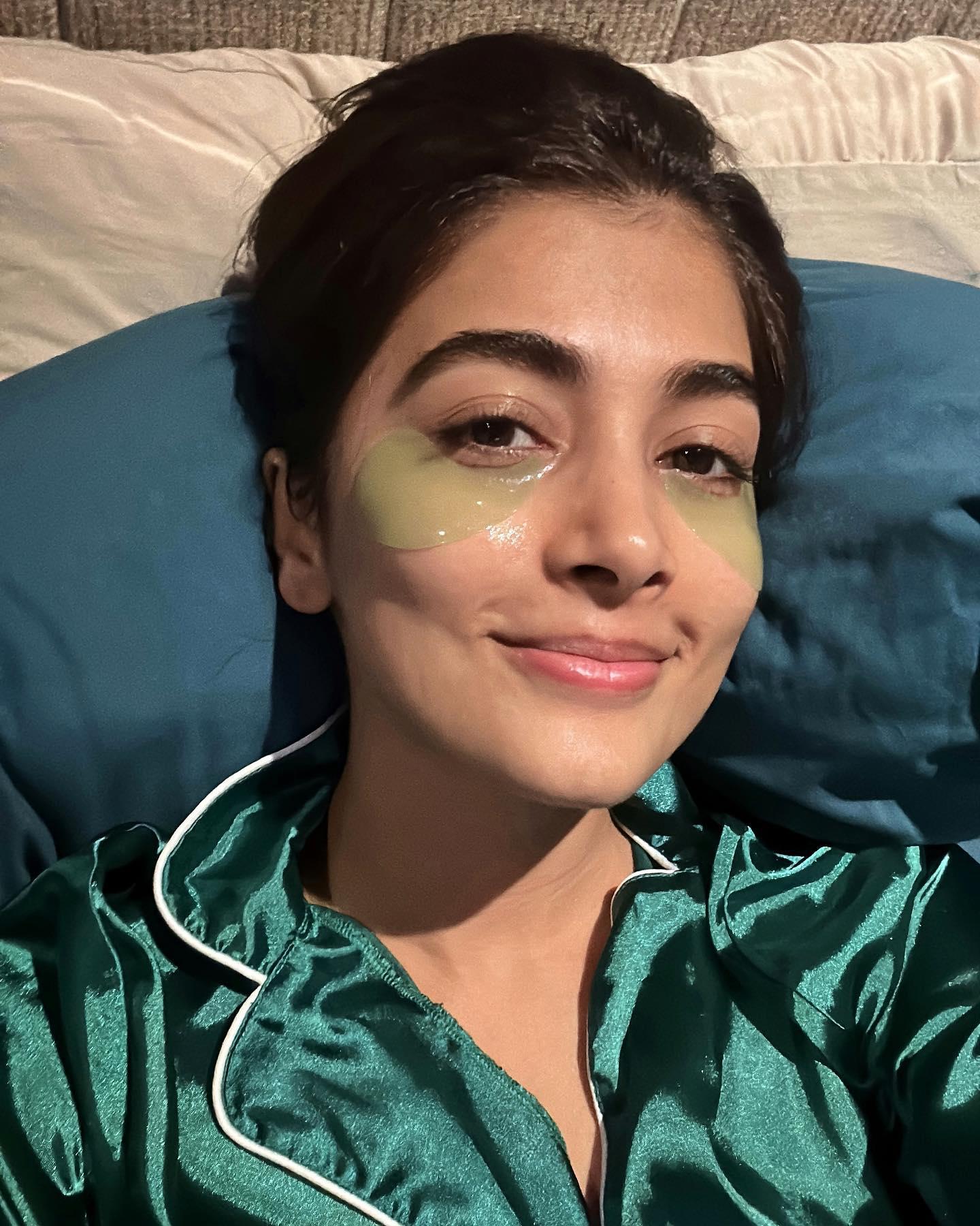 Pooja Hegde in Green Satin Nightwear Lying on Bed Wallpaper