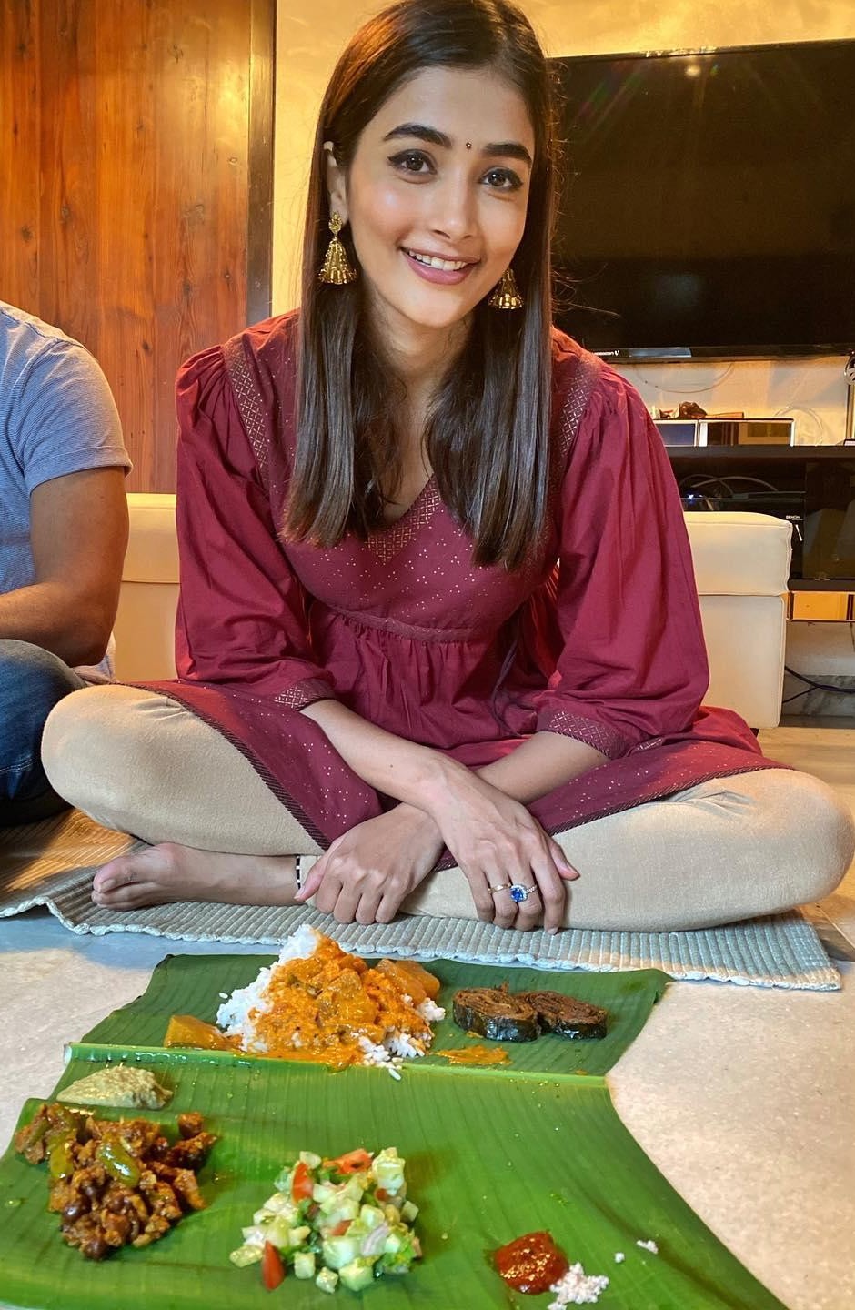 Pooja Hegde in Maroon Outfit Sitting with Traditional Meal