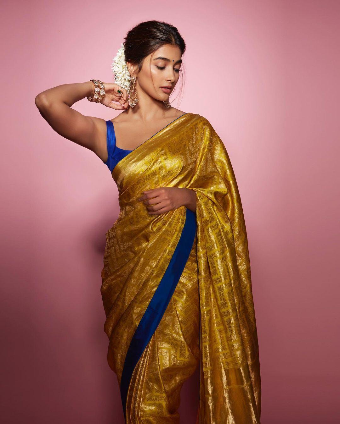 Pooja Hegde in Mustard Saree with Bold Blue Blouse Pose