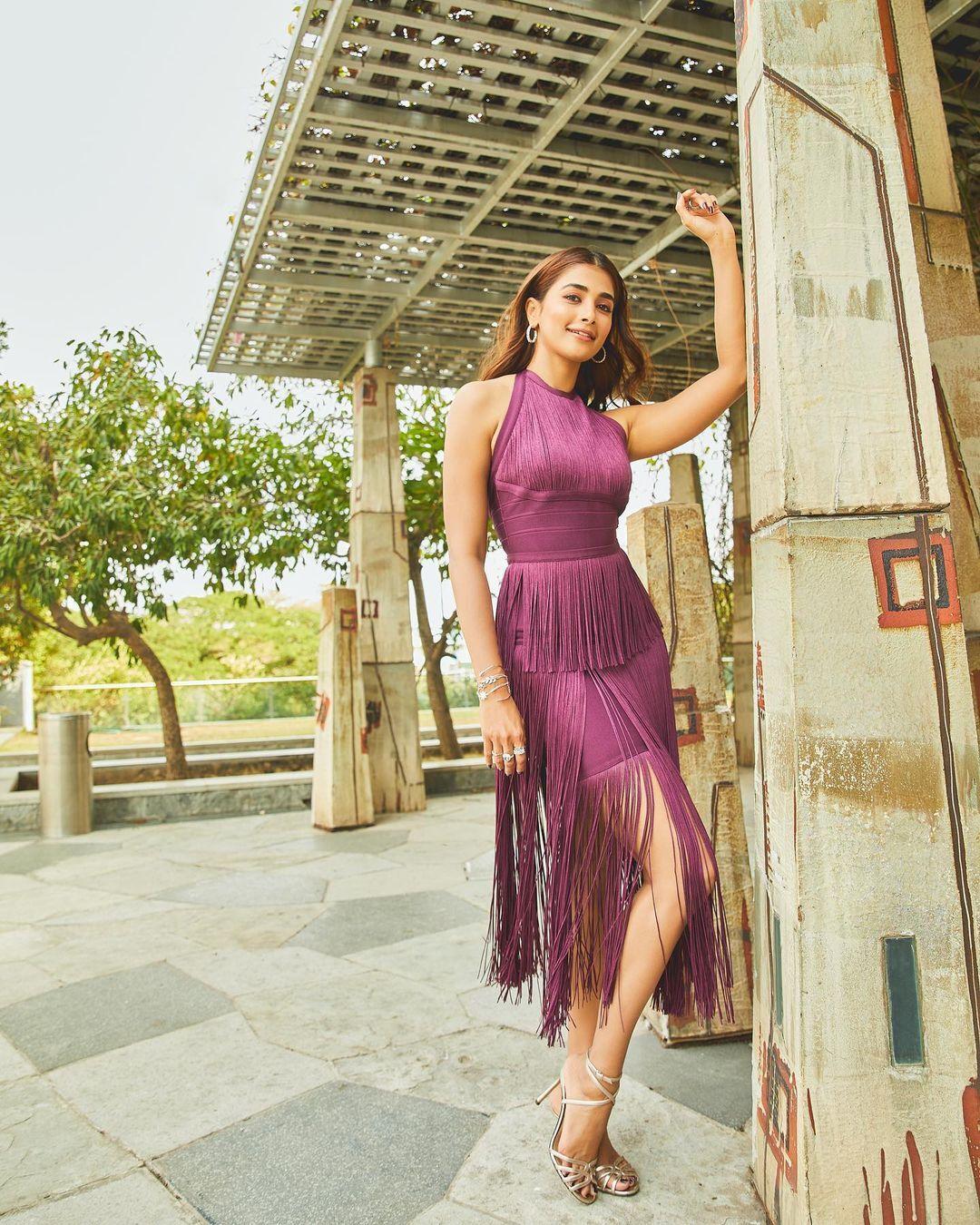 Pooja Hegde in Purple Dress Posing By Wooden Pillar Wallpaper