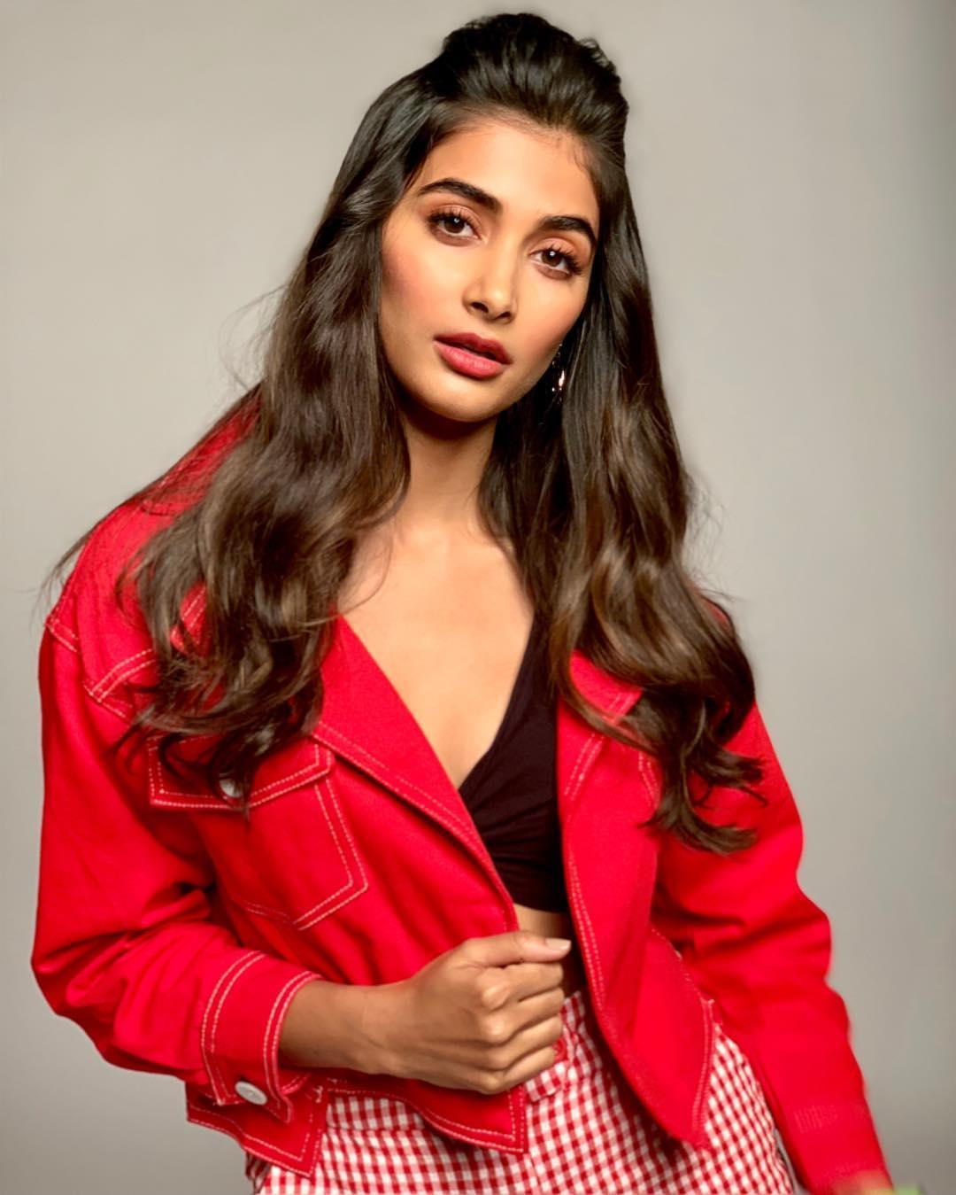 Pooja Hegde in Red Jacket Striking a Confident Pose Image