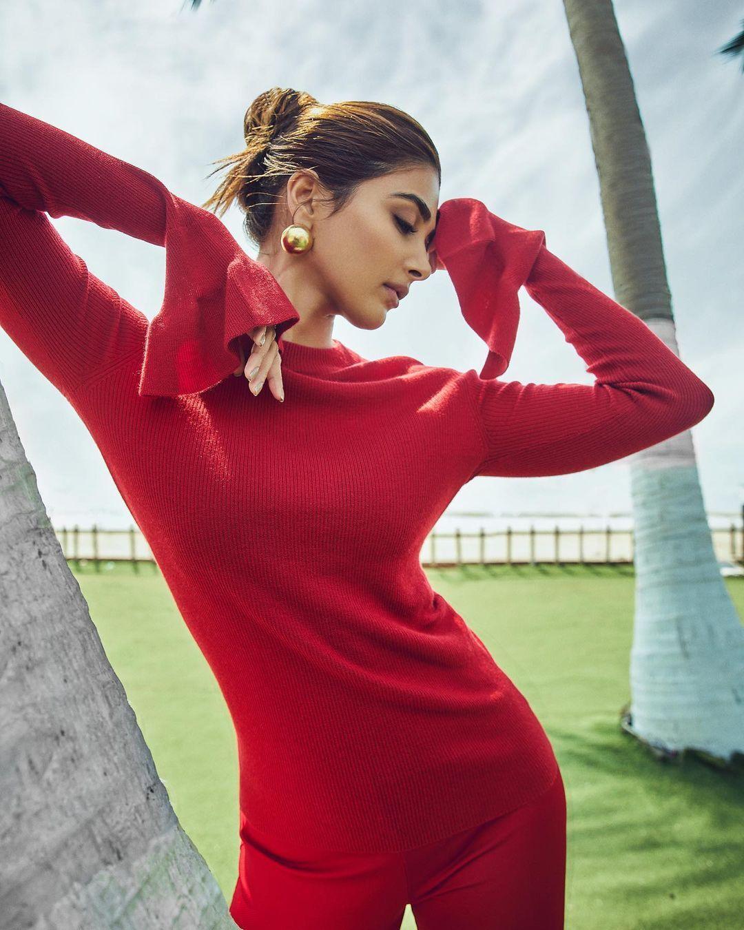 Pooja Hegde in Red Outfit Striking a Powerful Pose Wallpaper