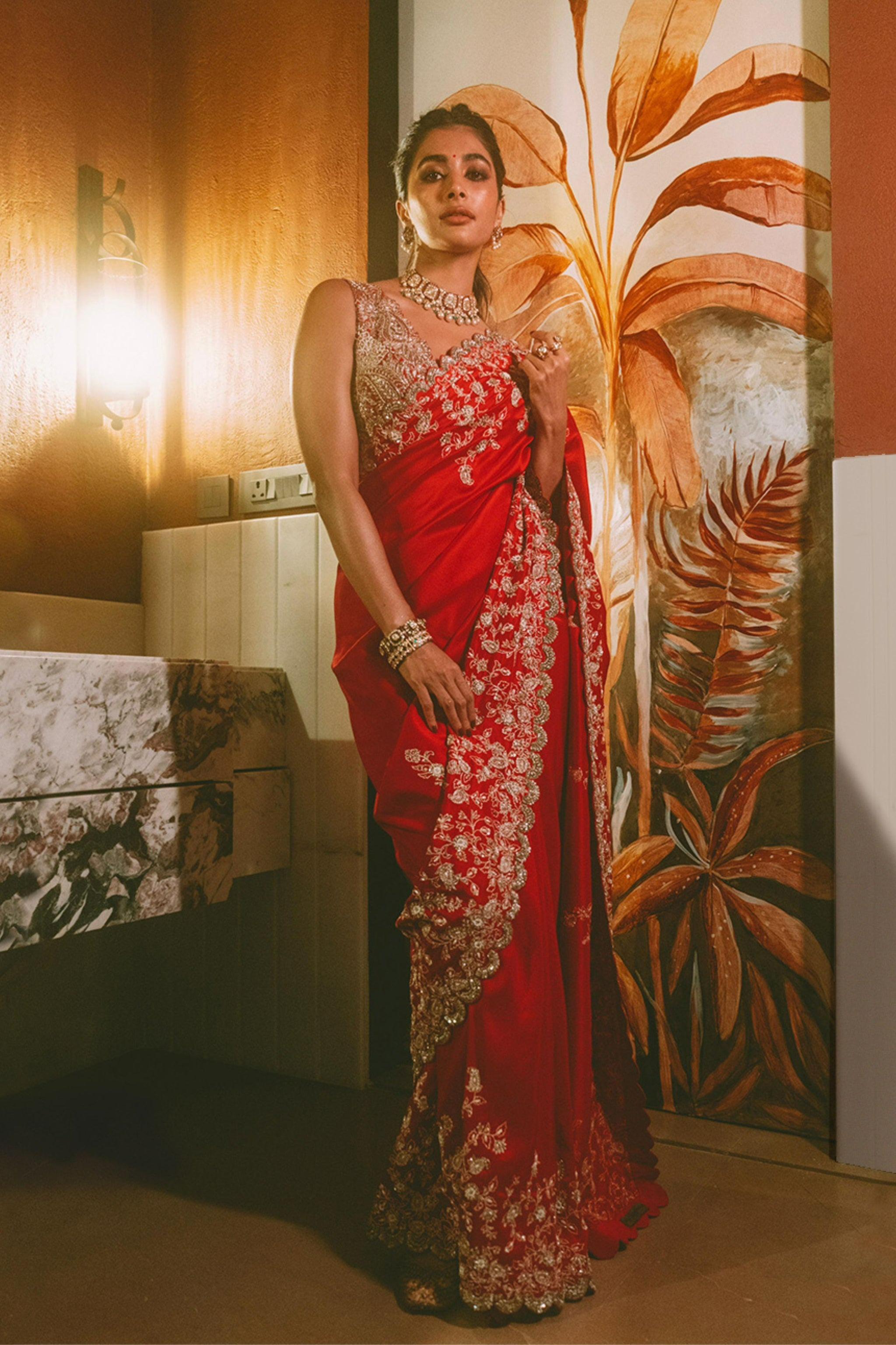 Pooja Hegde in Red Saree Posing with Floral Background