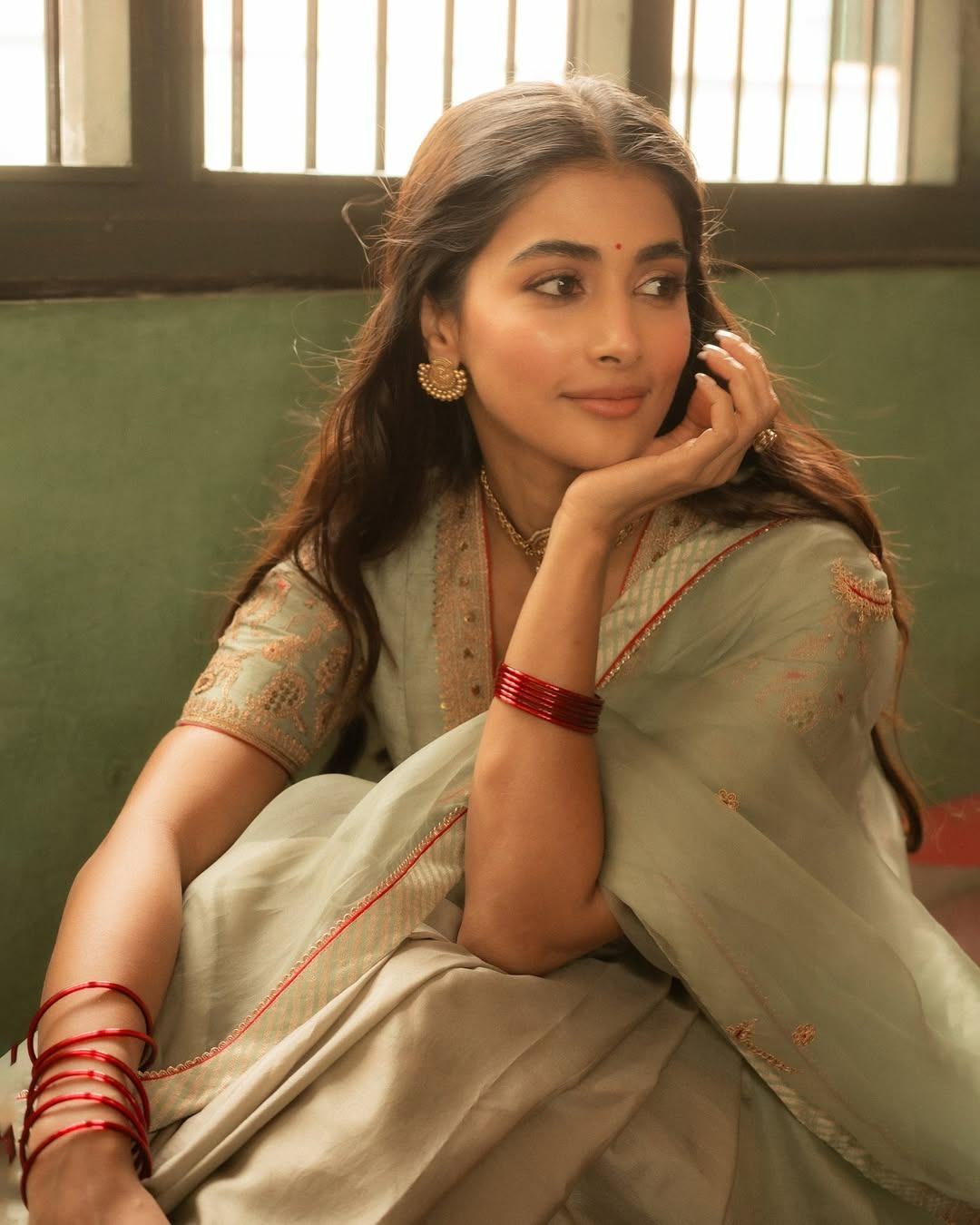 Pooja Hegde in Saree Sitting Gracefully Indoors Wallpaper