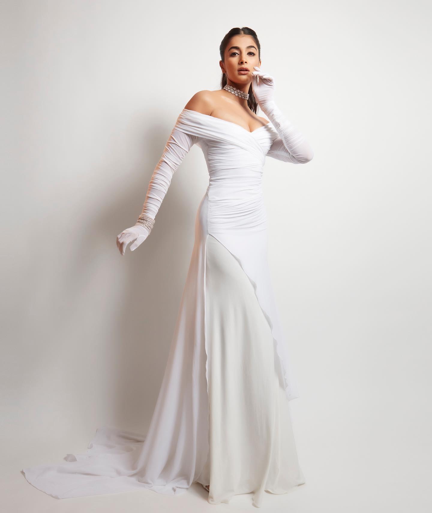 Pooja Hegde in White Gown with Long Gloves and Chic Pose