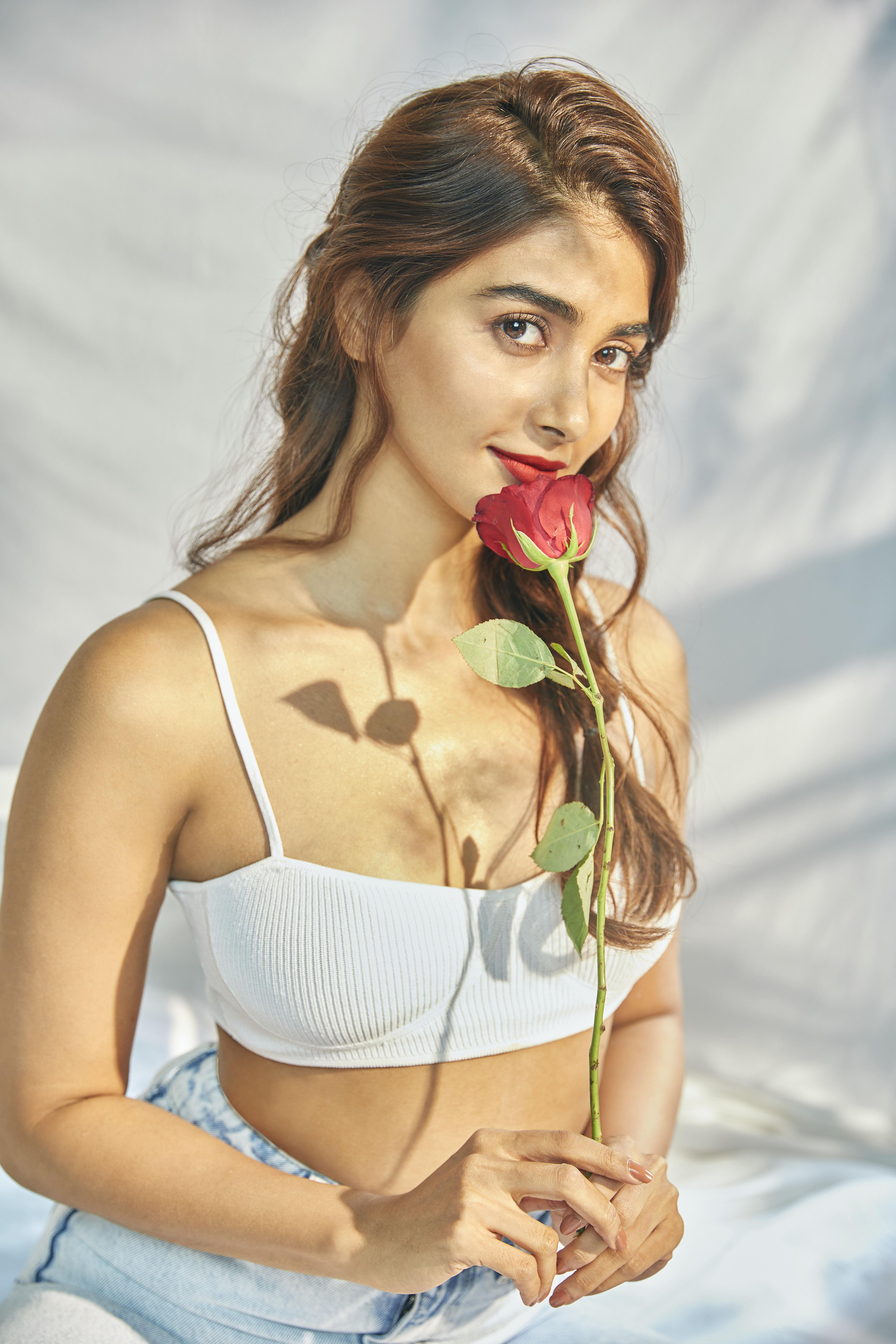 Pooja Hegde in White Tube Top with Rose in Soft Lighting