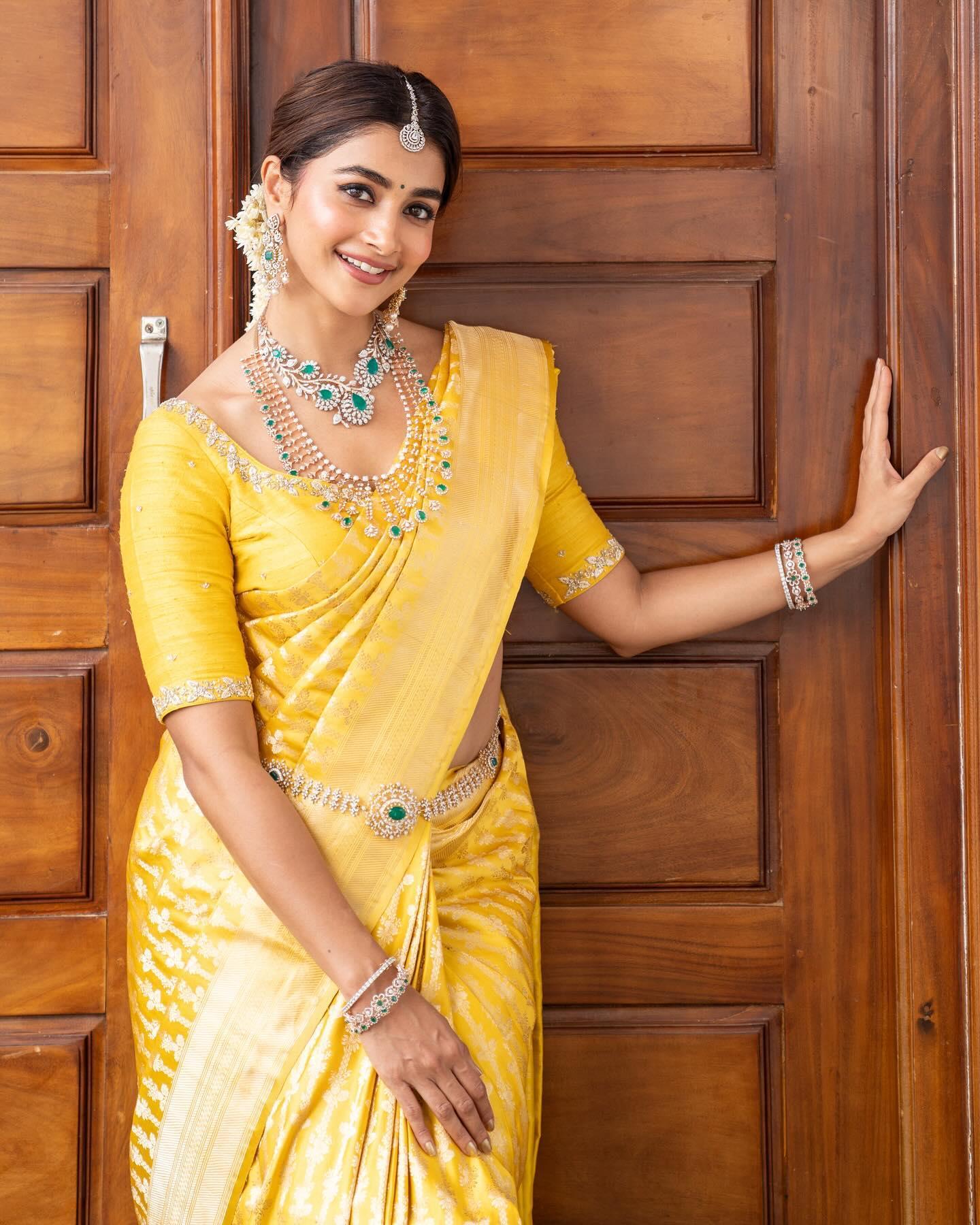Pooja Hegde in Yellow Saree Posing By Wooden Door Wallpaper