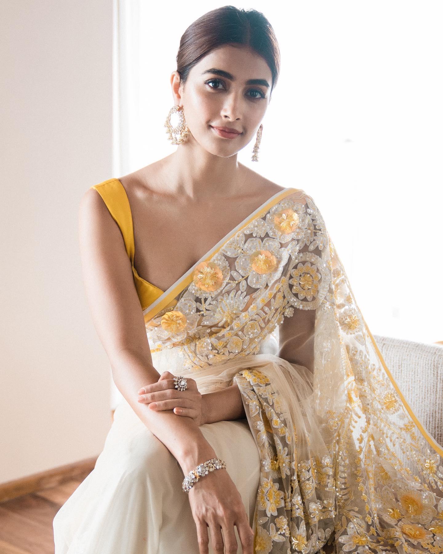 Pooja Hegde in Yellow Saree Sitting Gracefully Indoors