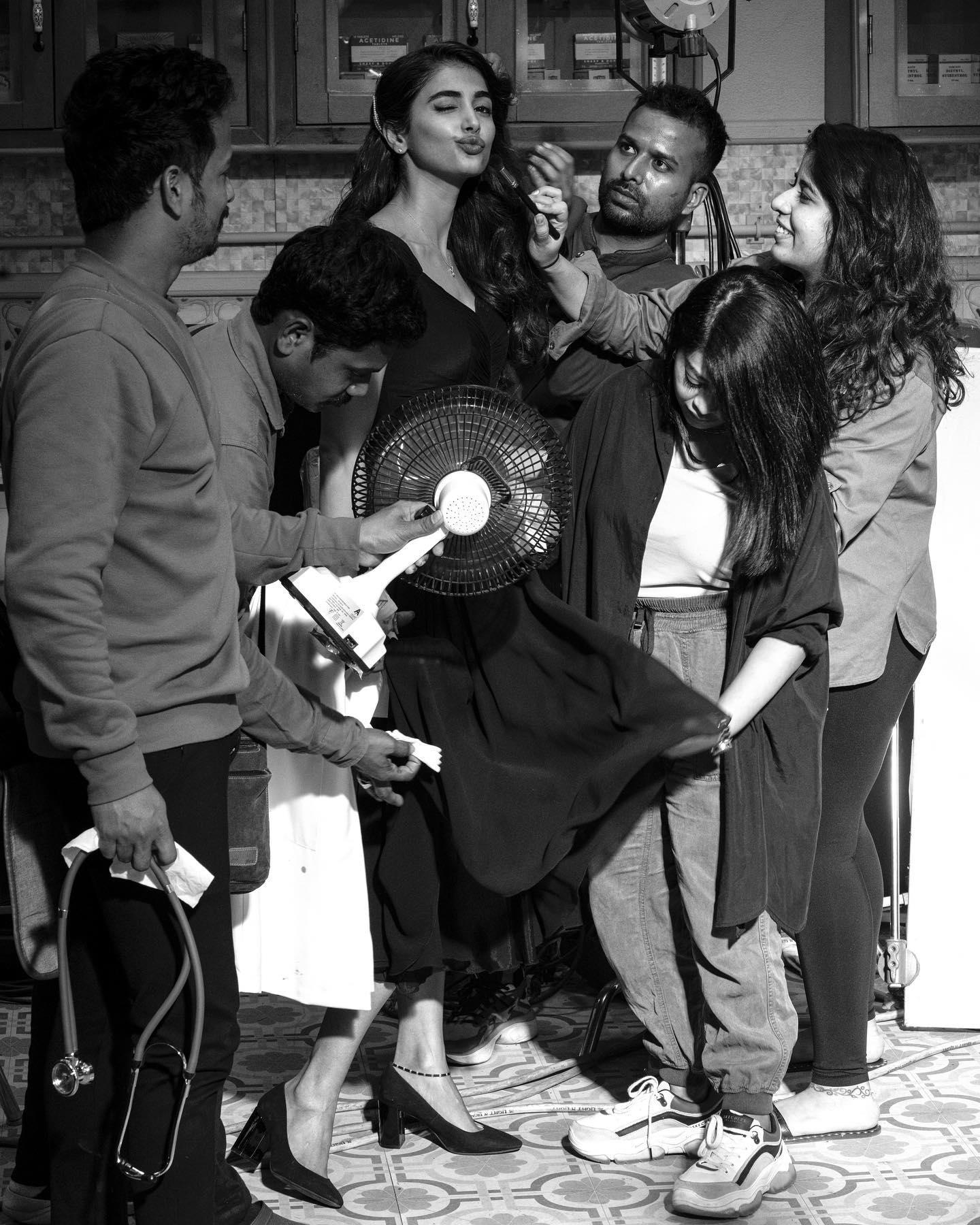 Pooja Hegde Laughs with Team in Black and White Photo