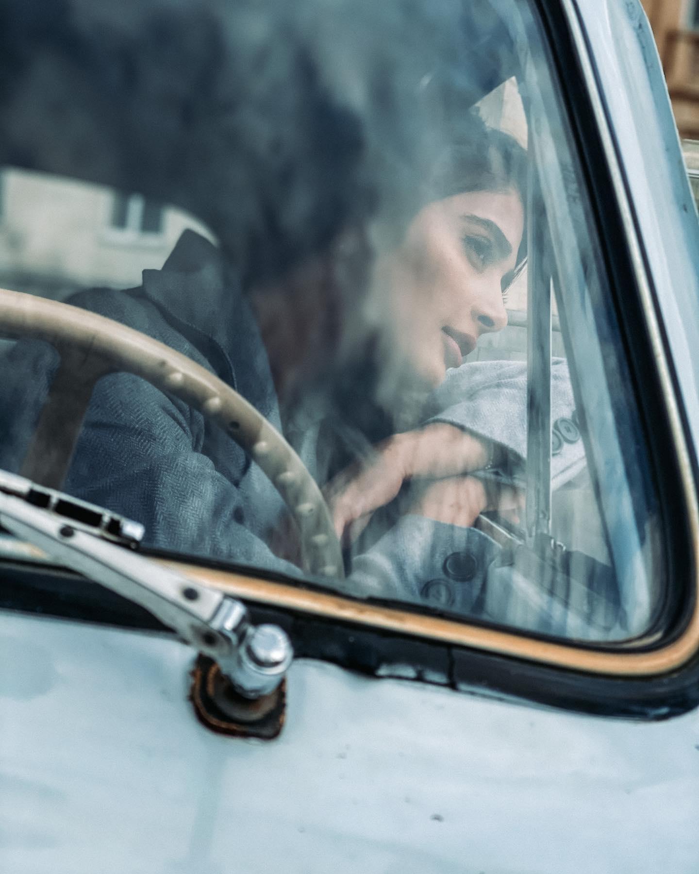 Pooja Hegde Looking Thoughtful Inside a Vintage Car