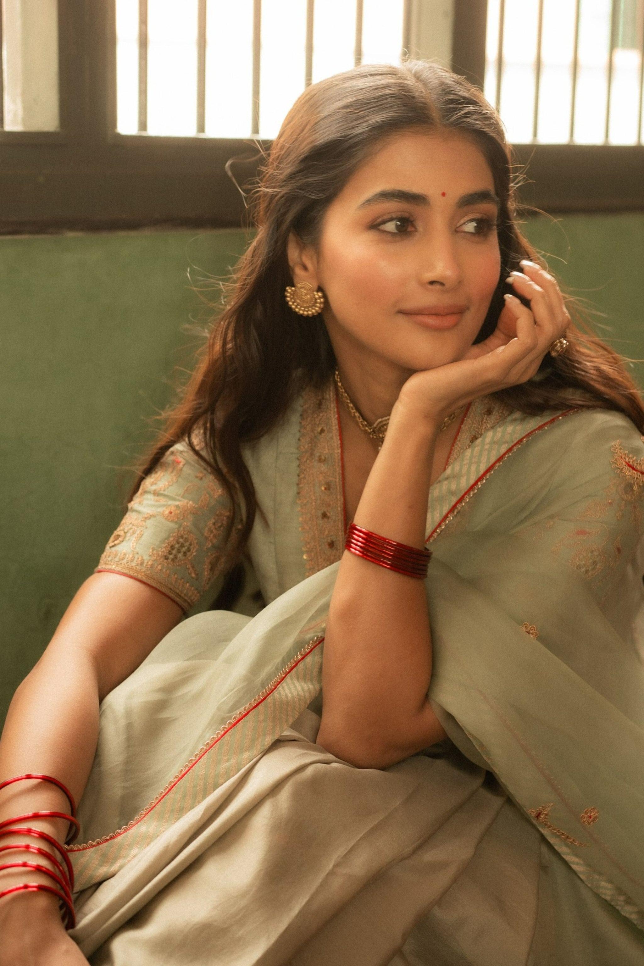Pooja Hegde Looks Thoughtful in Olive Saree By the Window