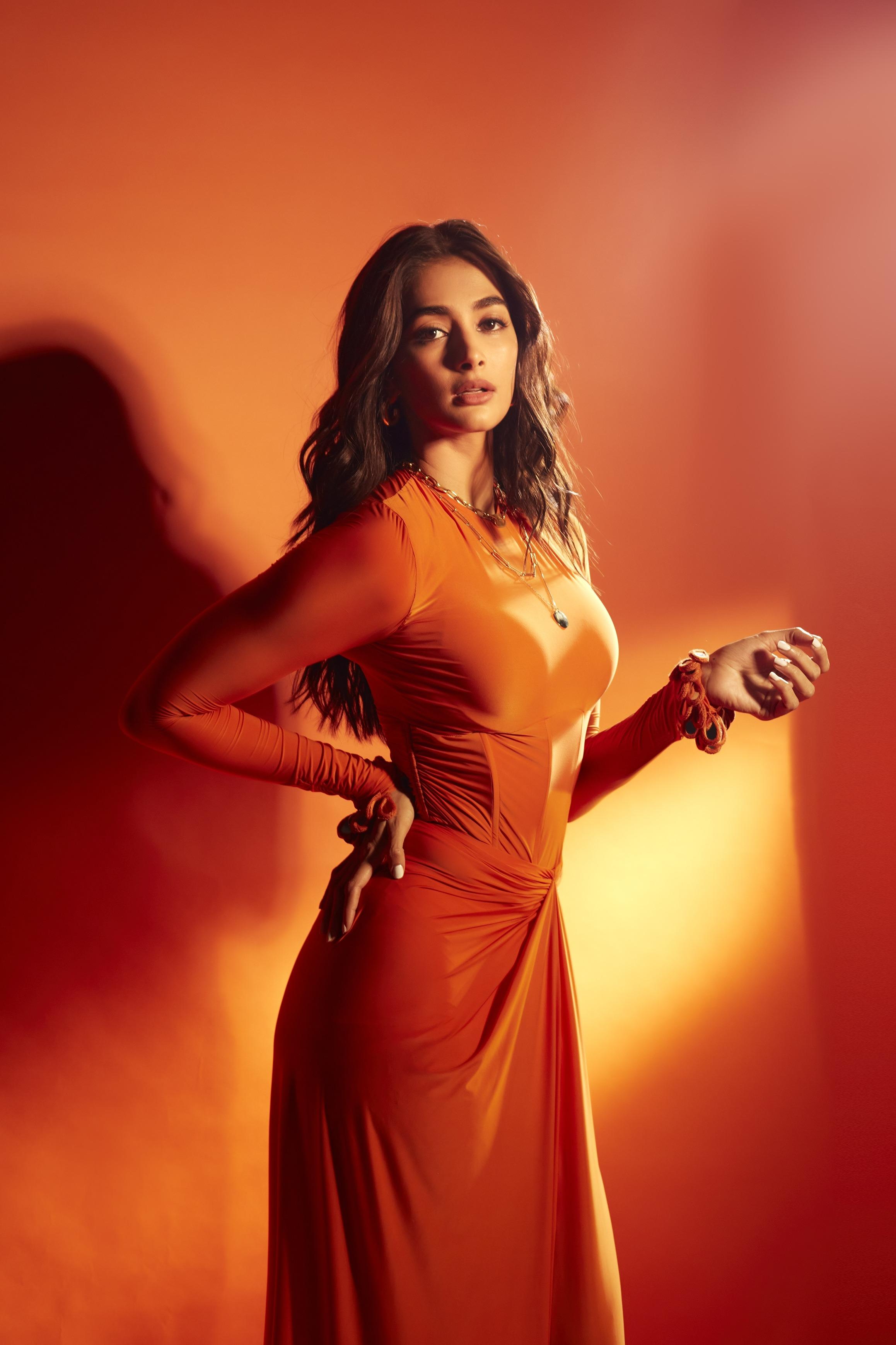 Pooja Hegde Poses Confidently in Orange Gown Wallpaper