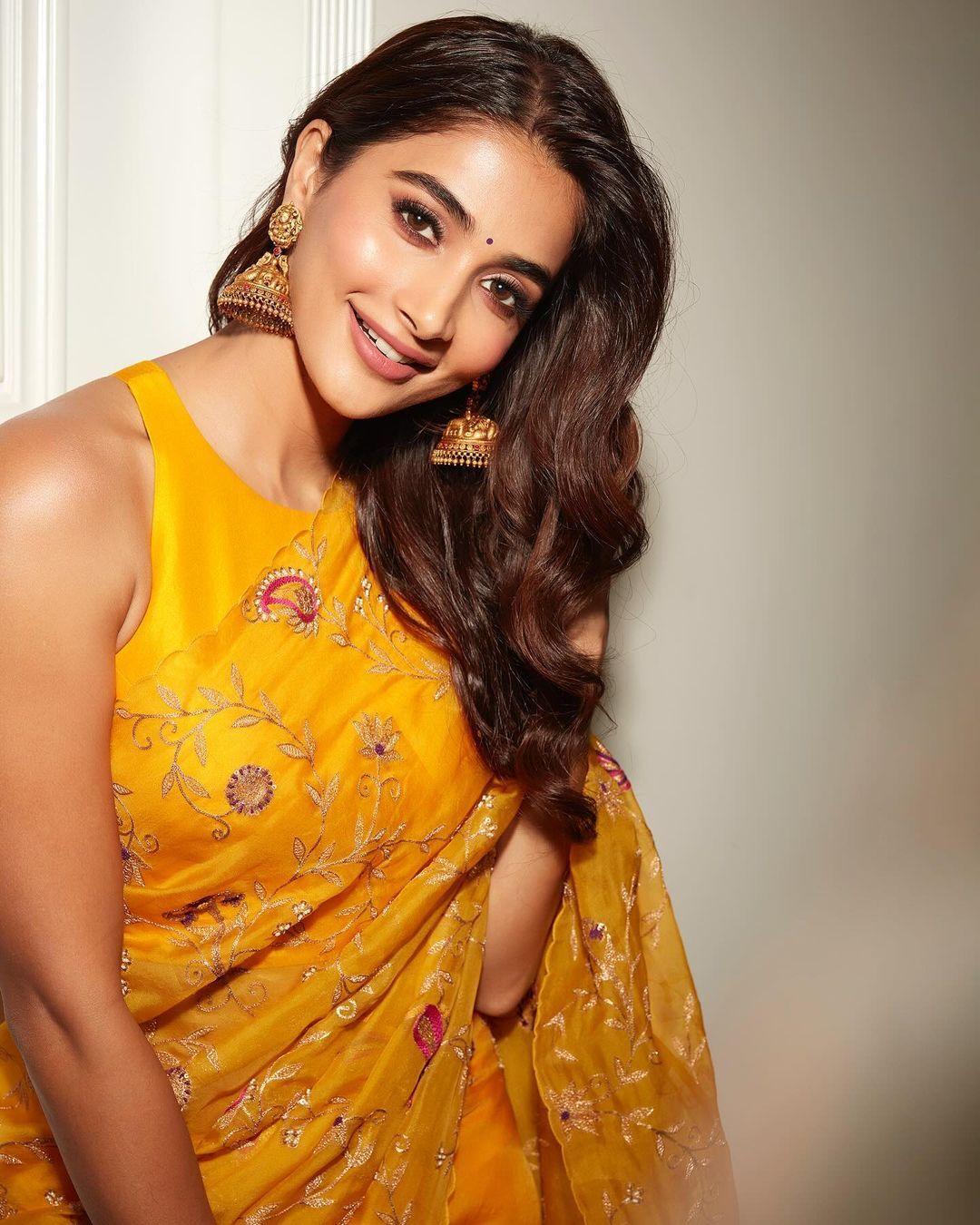 Pooja Hegde Posing Gracefully in Bright Yellow Indian Dress
