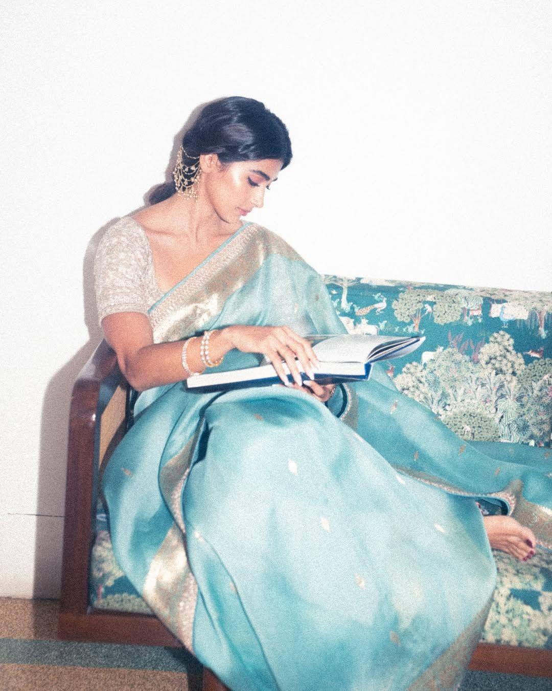 Pooja Hegde Reading a Book Dressed in Light Saree Wallpaper