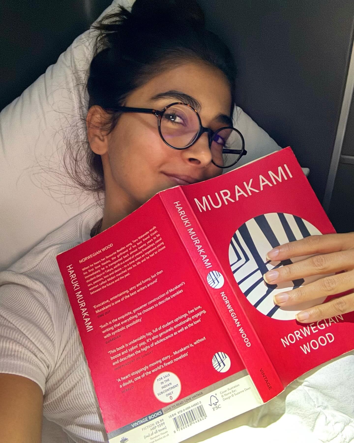 Pooja Hegde Reading in Bed Holding Red Murakami Book