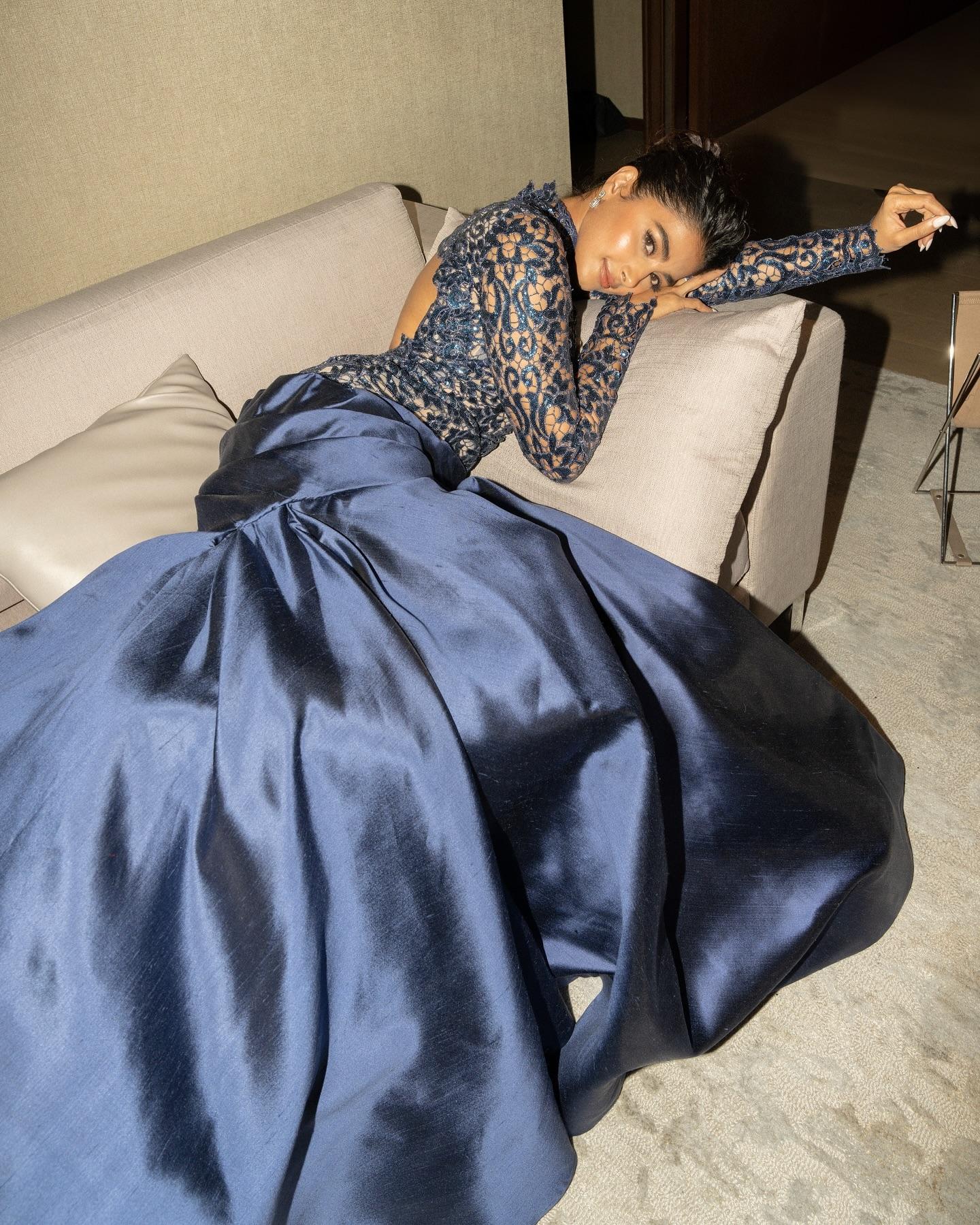 Pooja Hegde Relaxes in Sofa Wearing Deep Blue Gown