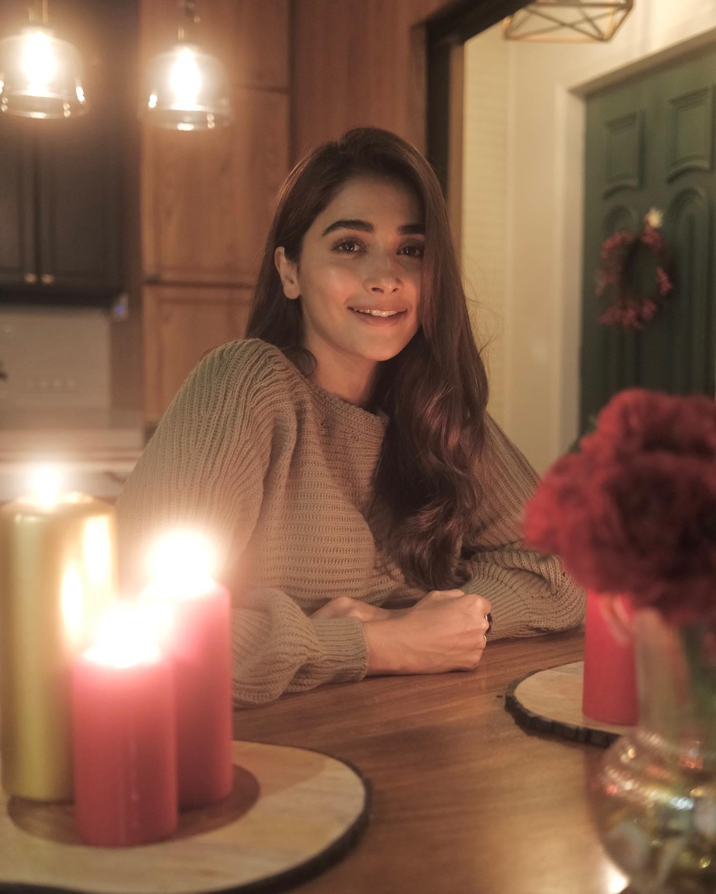 Pooja Hegde Relaxing Indoors By Candlelight Wallpaper