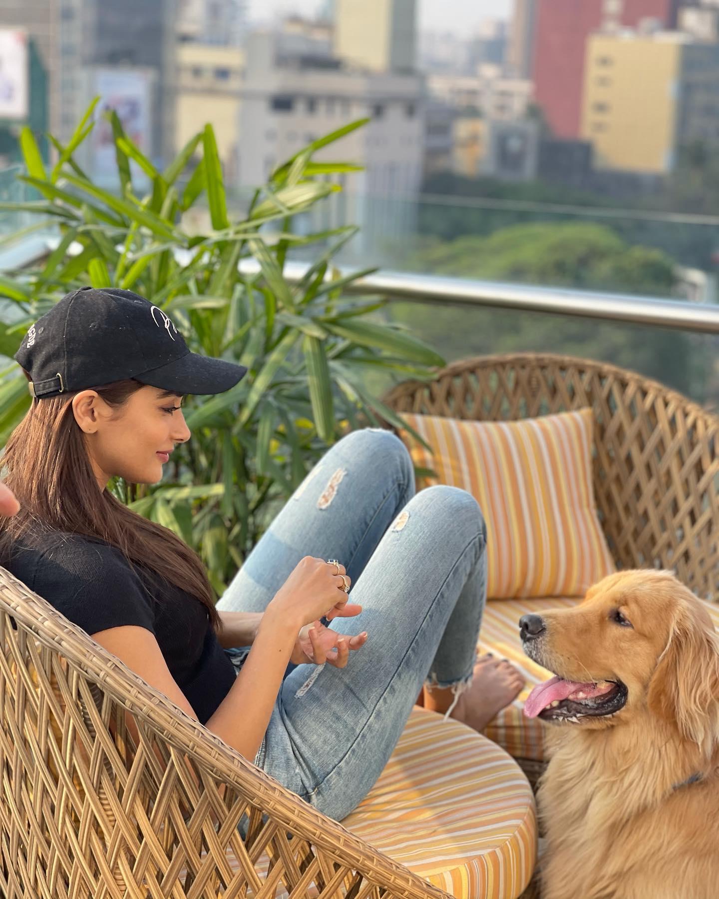 Pooja Hegde Relaxing with Dog on Balcony in Casual Wear