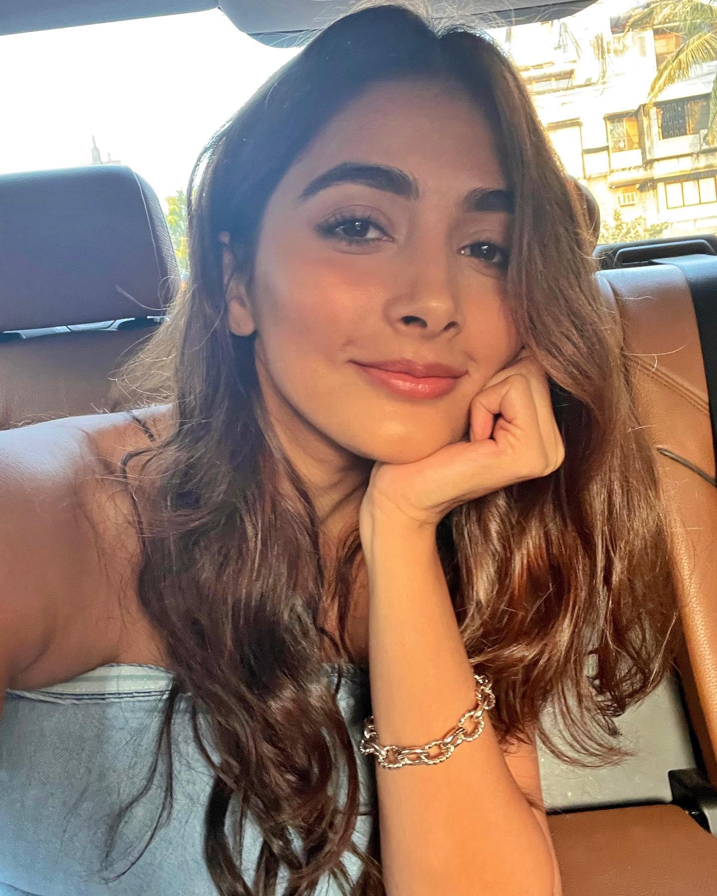 Pooja Hegde Resting Chin on Hand While Smiling in Car