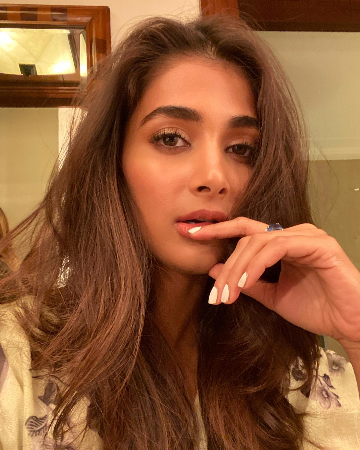 Pooja Hegde Resting Her Chin with Confident Expression