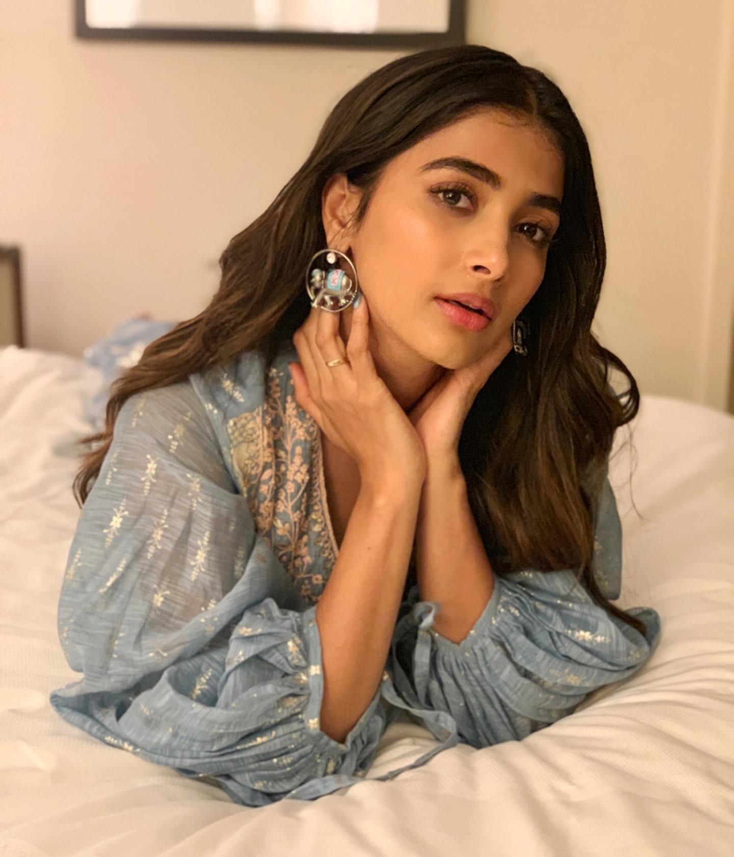 Pooja Hegde Resting with Hands on Neck in Soft Light