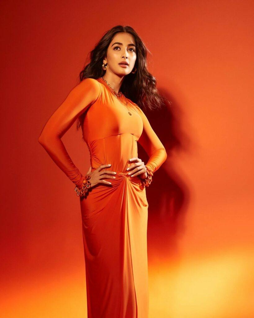 Pooja Hegde Shines in Bold Orange Dress with Power Pose