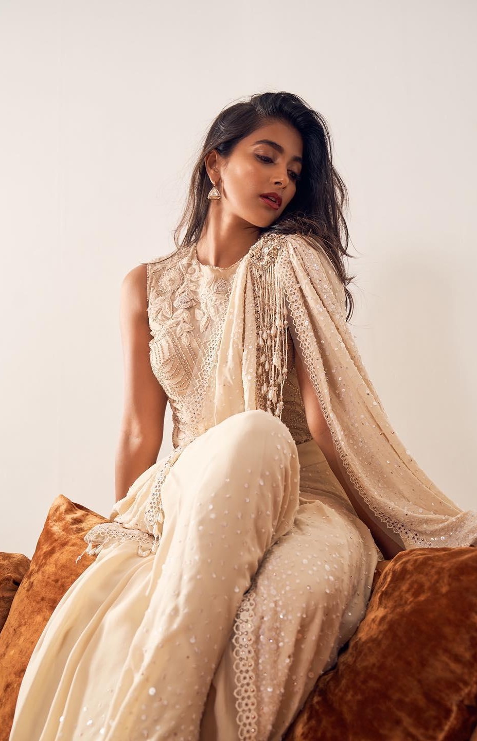 Pooja Hegde Sitting Calmly in a Soft Beige Outfit