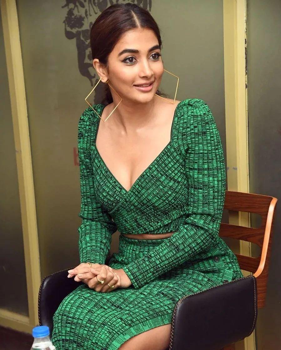 Pooja Hegde Sitting in Green Dress During An Event