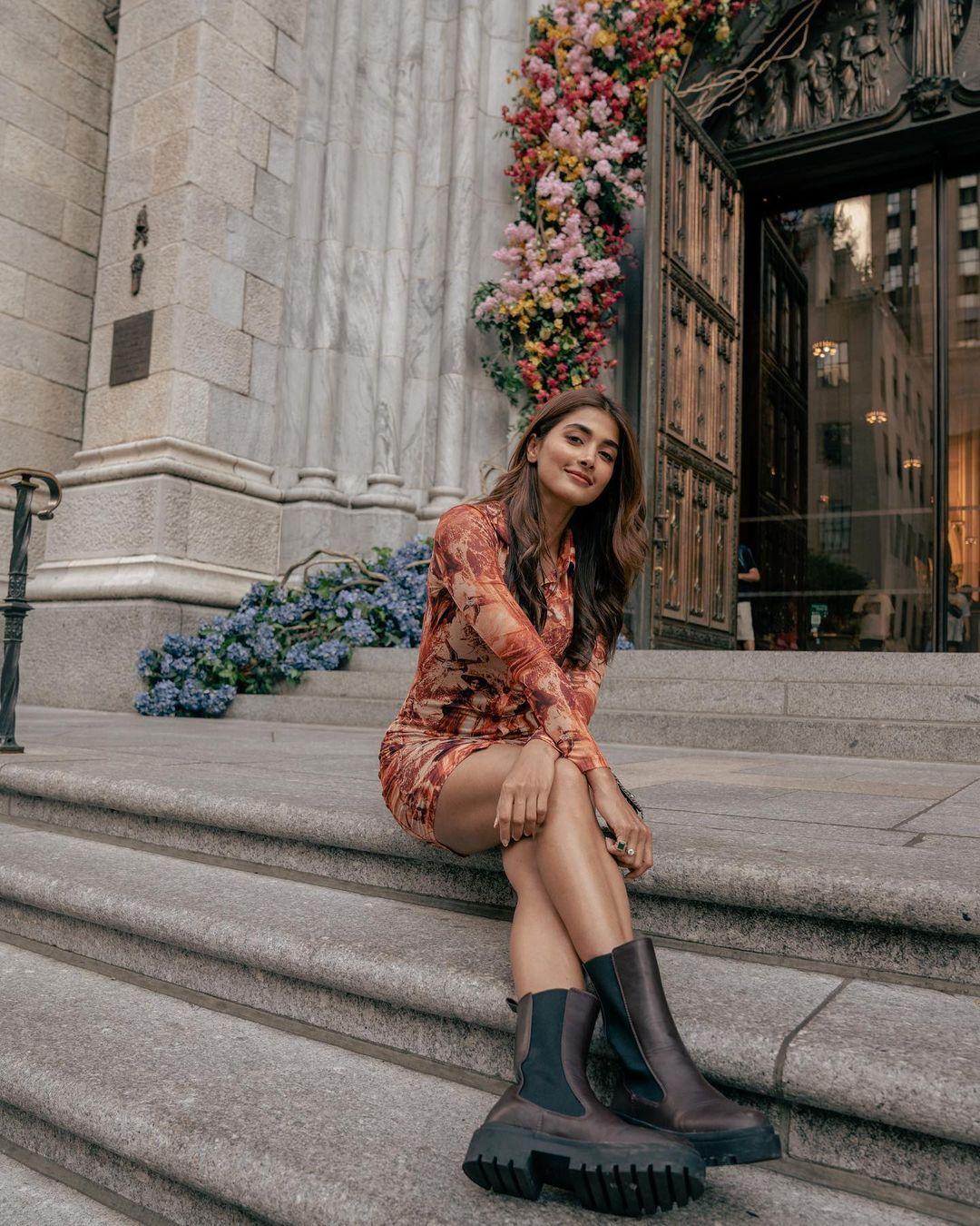 Pooja Hegde Sitting on City Steps in Checkered Outfit