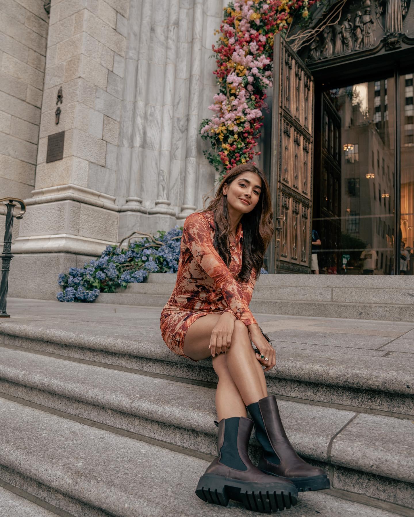 Pooja Hegde Sitting on Steps in Printed Dress Outdoors