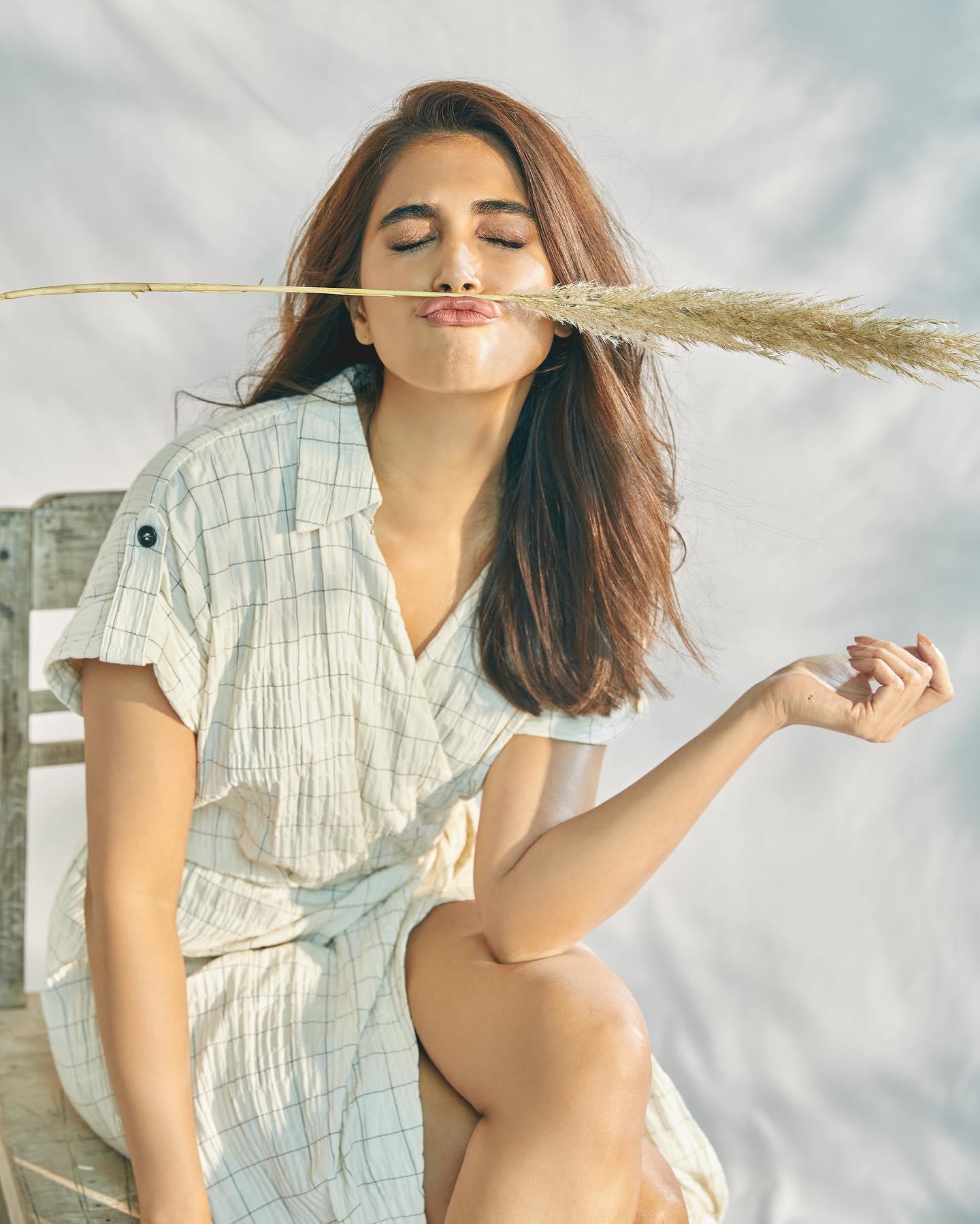 Pooja Hegde Sitting Outdoors with Relaxed Expression