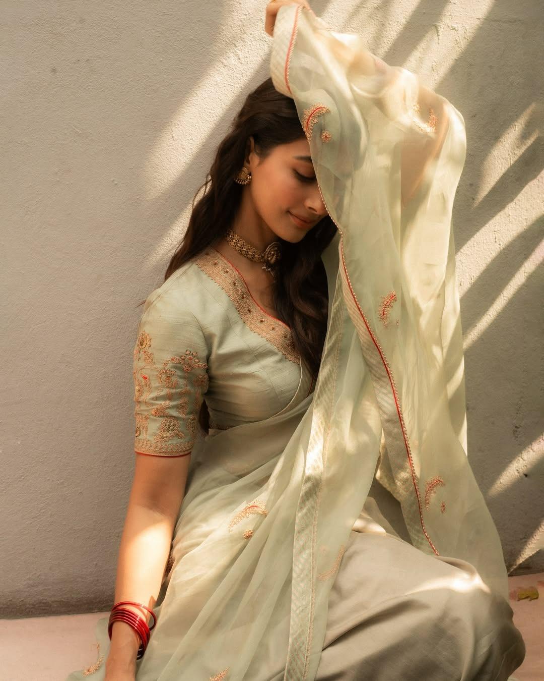 Pooja Hegde Sitting with Traditional Dress Near Window Light