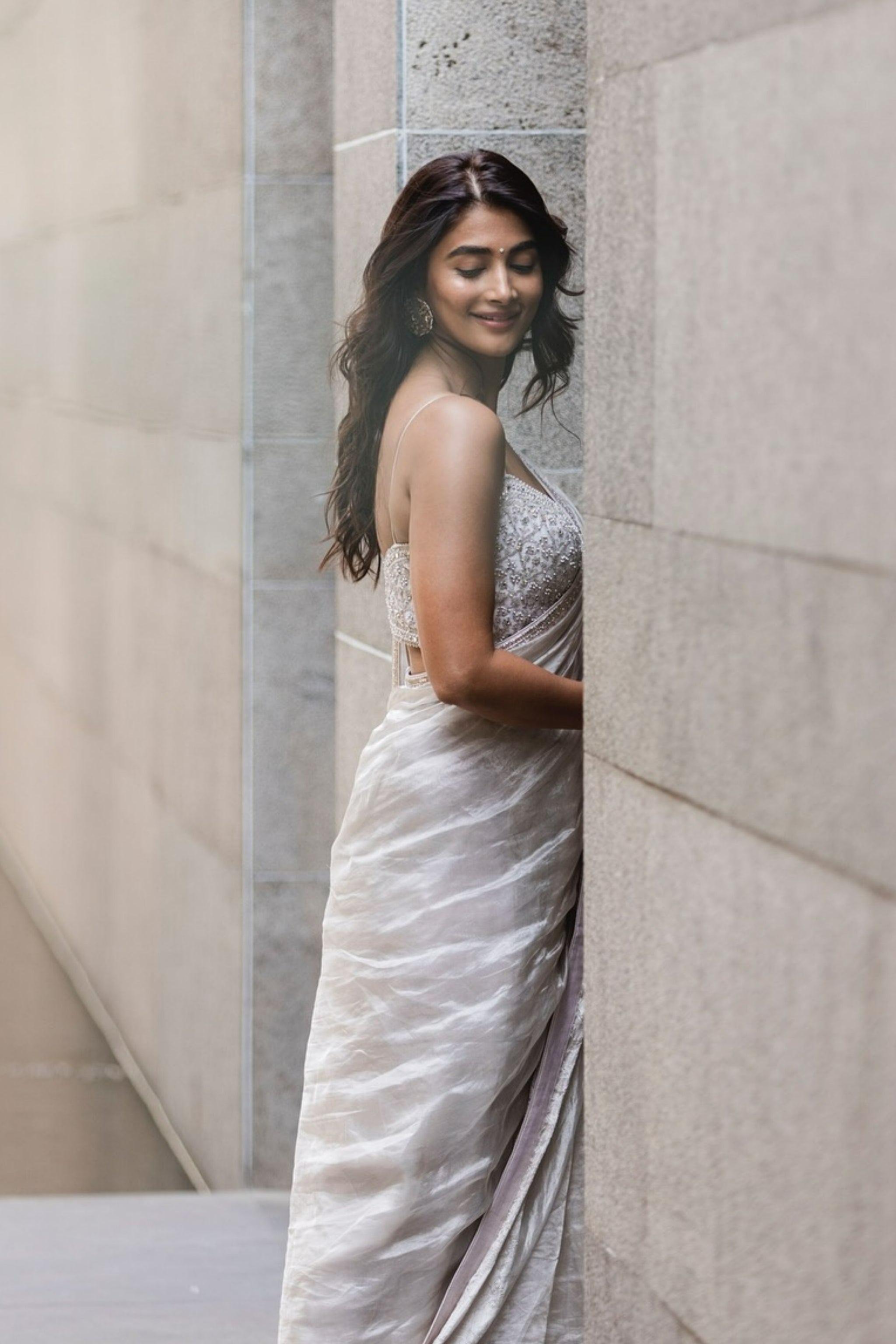 Pooja Hegde Smiles in Silver Saree By Stone Wall Wallpaper