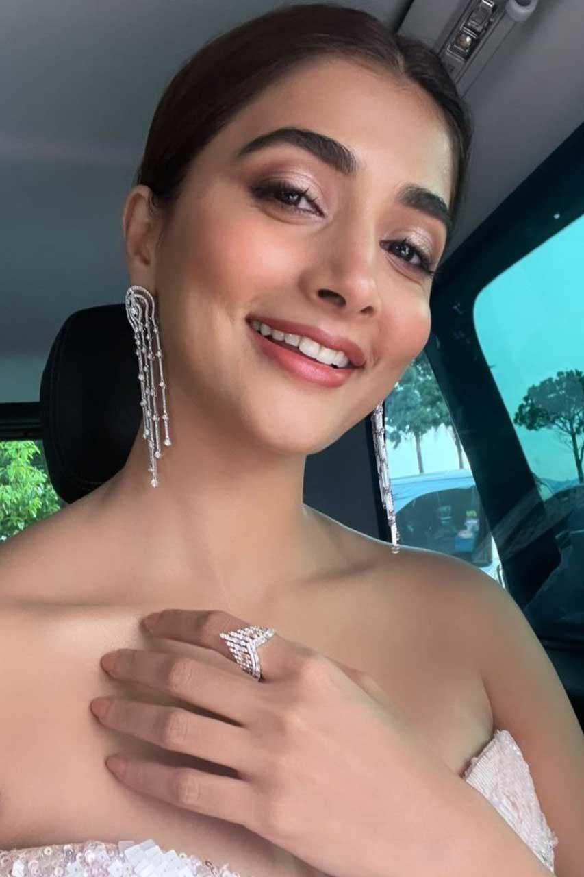Pooja Hegde Smiling in Car Wearing White Off Shoulder Dress