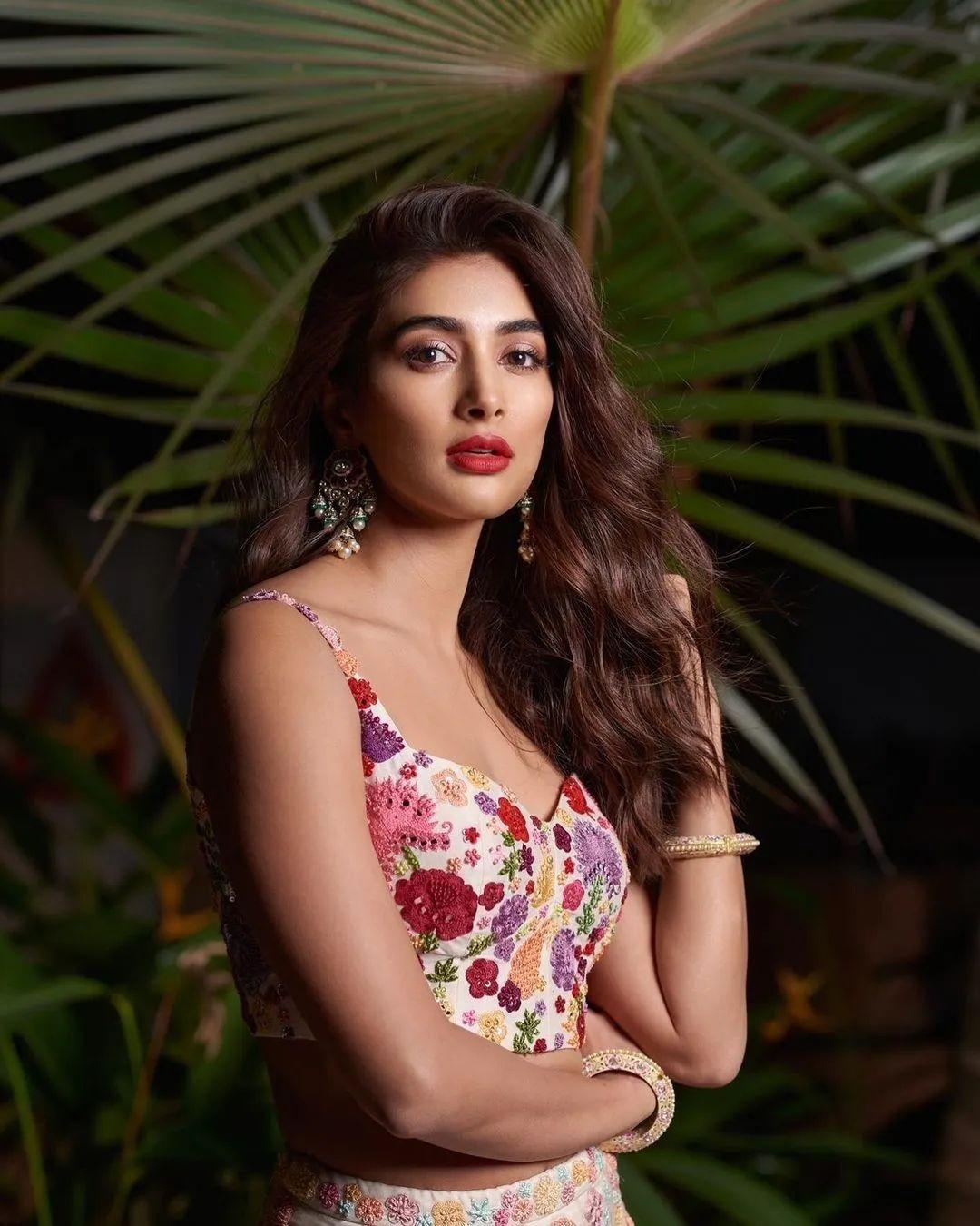 Pooja Hegde Standing in Floral Dress with Plants Background