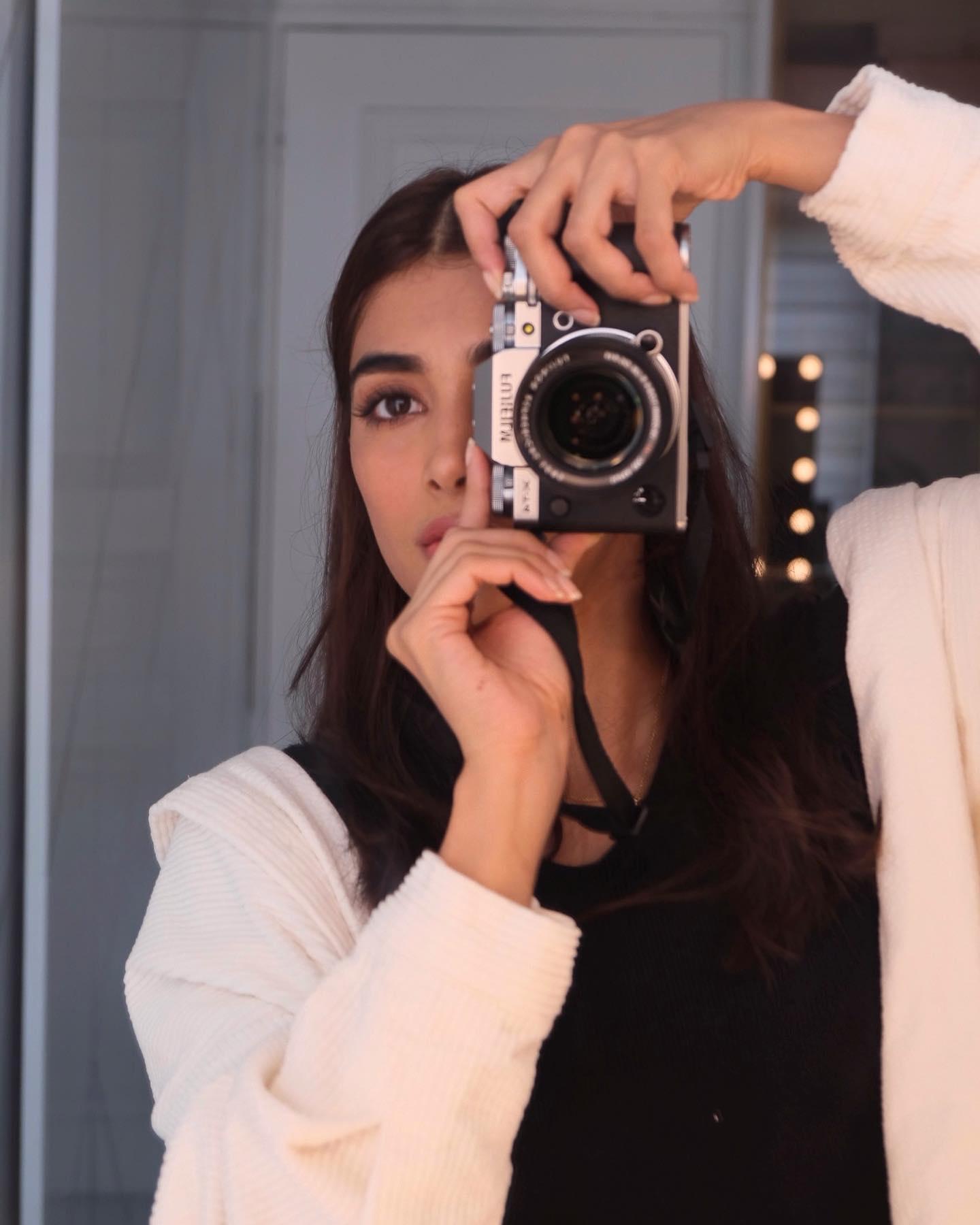 Pooja Hegde Taking Mirror Selfie Wearing White Hoodie
