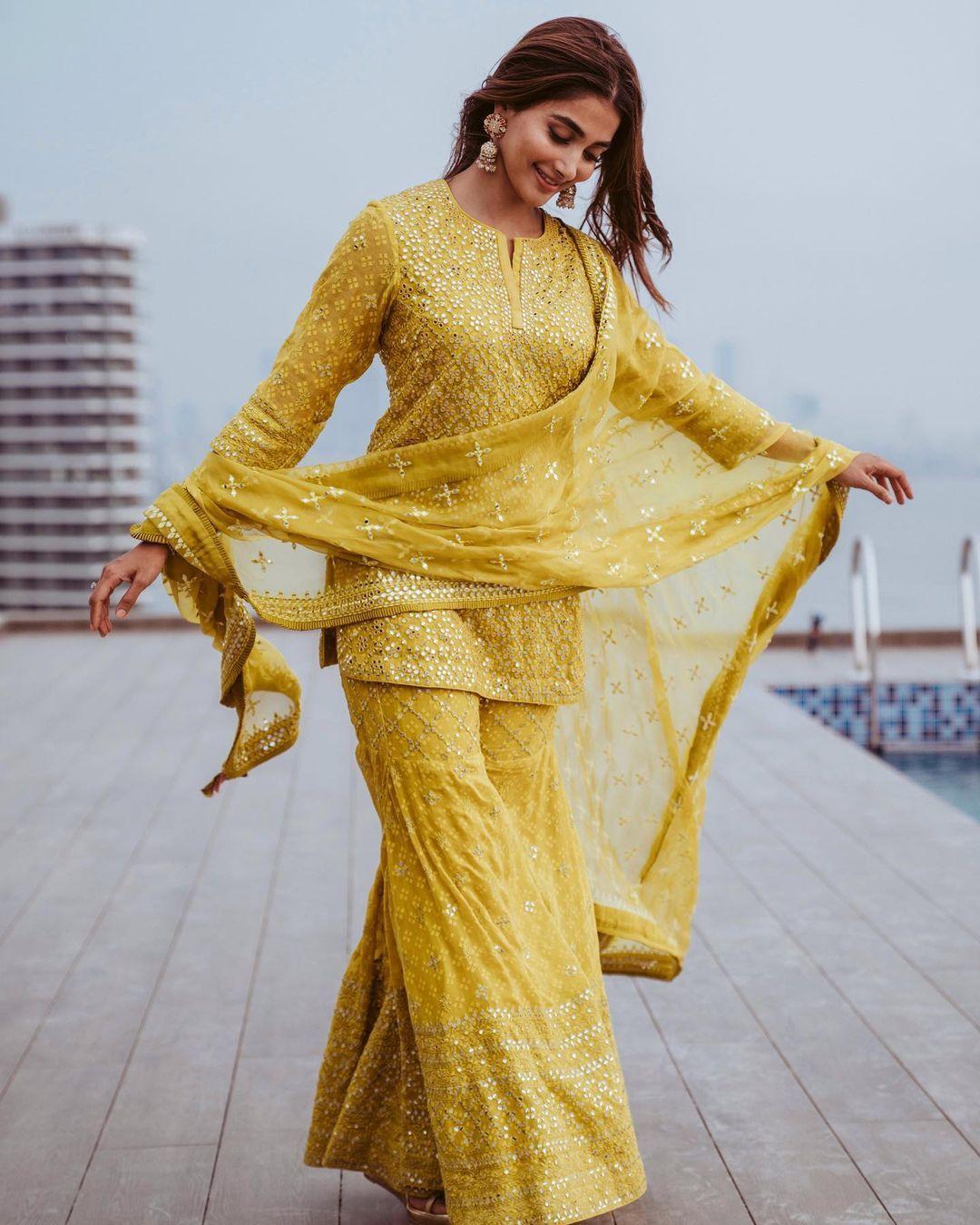 Pooja Hegde Twirling in Bright Yellow Outfit on Terrace