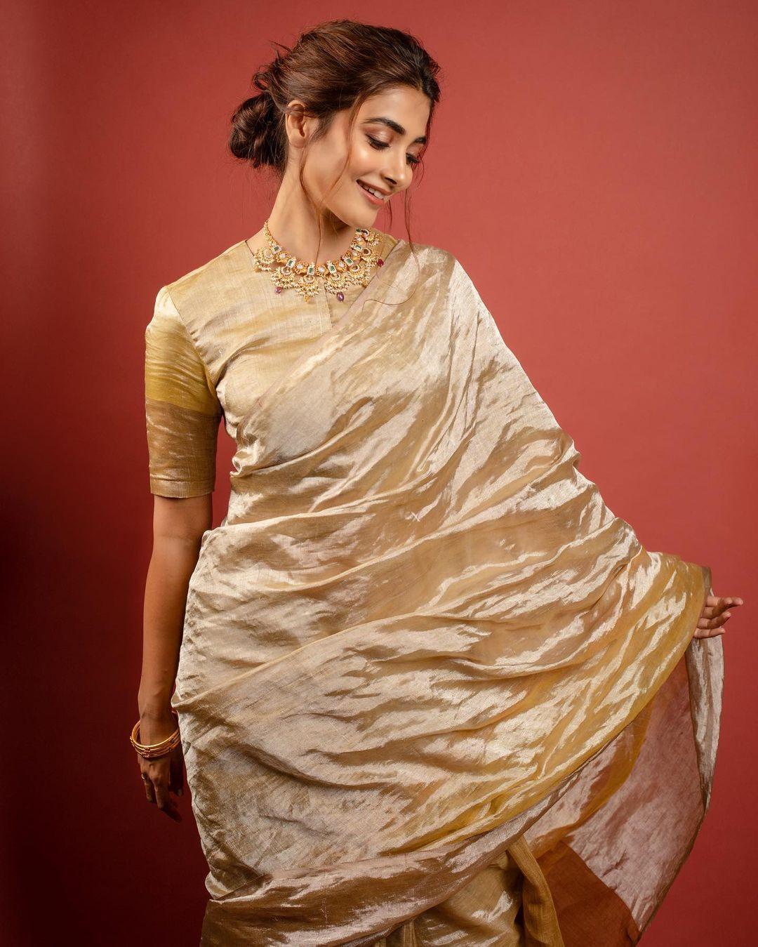 Pooja Hegde Twirling in Traditional Golden Saree Wallpaper
