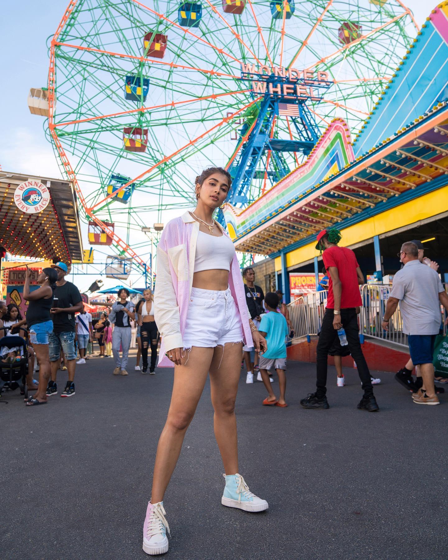 Pooja Hegde Walking At Carnival in White Top and Shorts