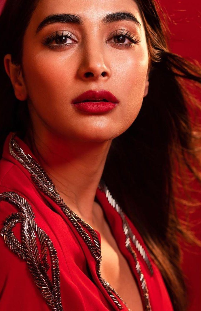 Pooja Hegde Wearing Red Outfit with Bold Makeup Looking Away